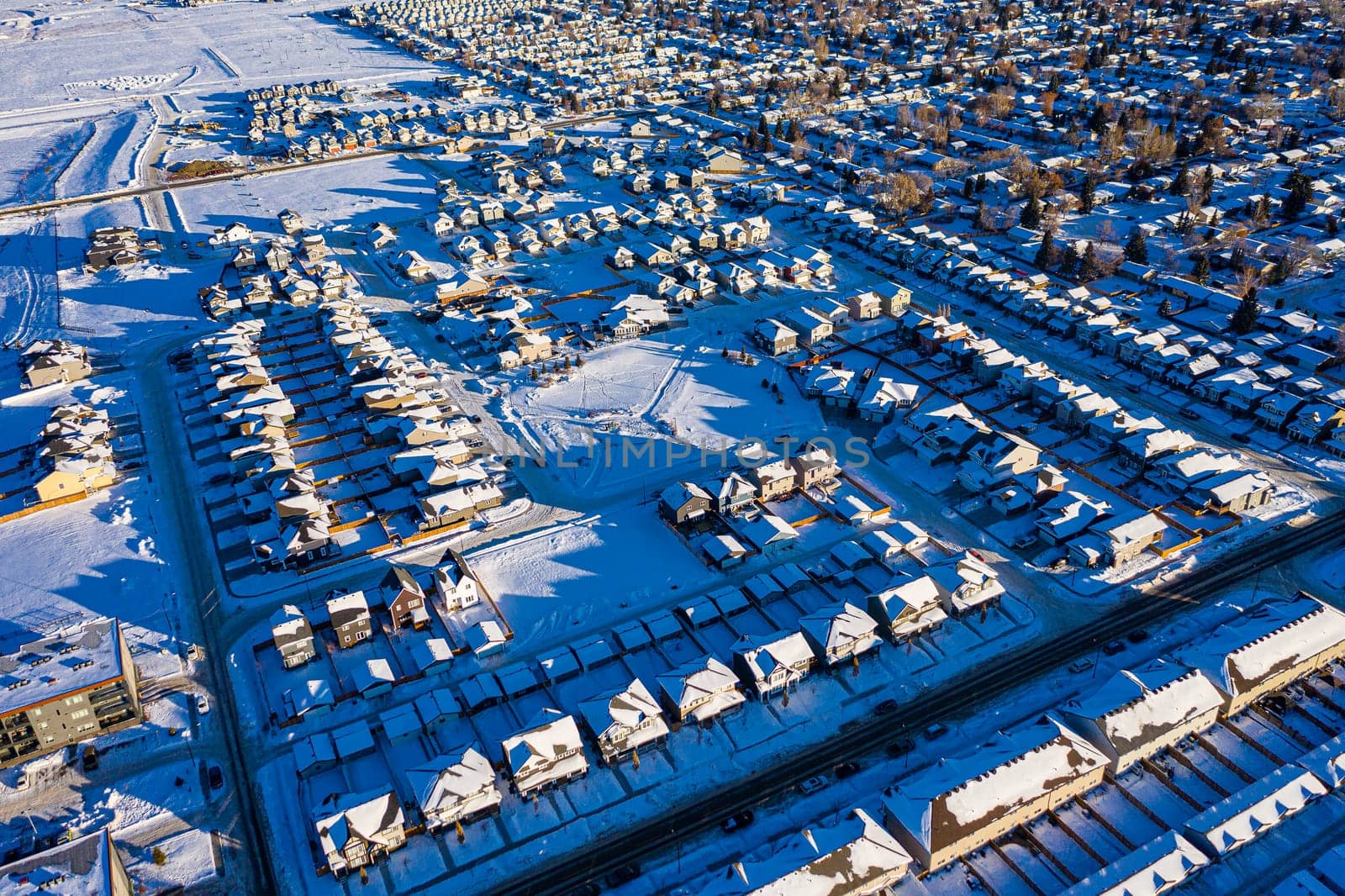 Discover Kensington in Saskatoon from a bird's-eye view. This drone image highlights the neighborhood's modern architecture, green spaces, and the lively, community-focused atmosphere.
