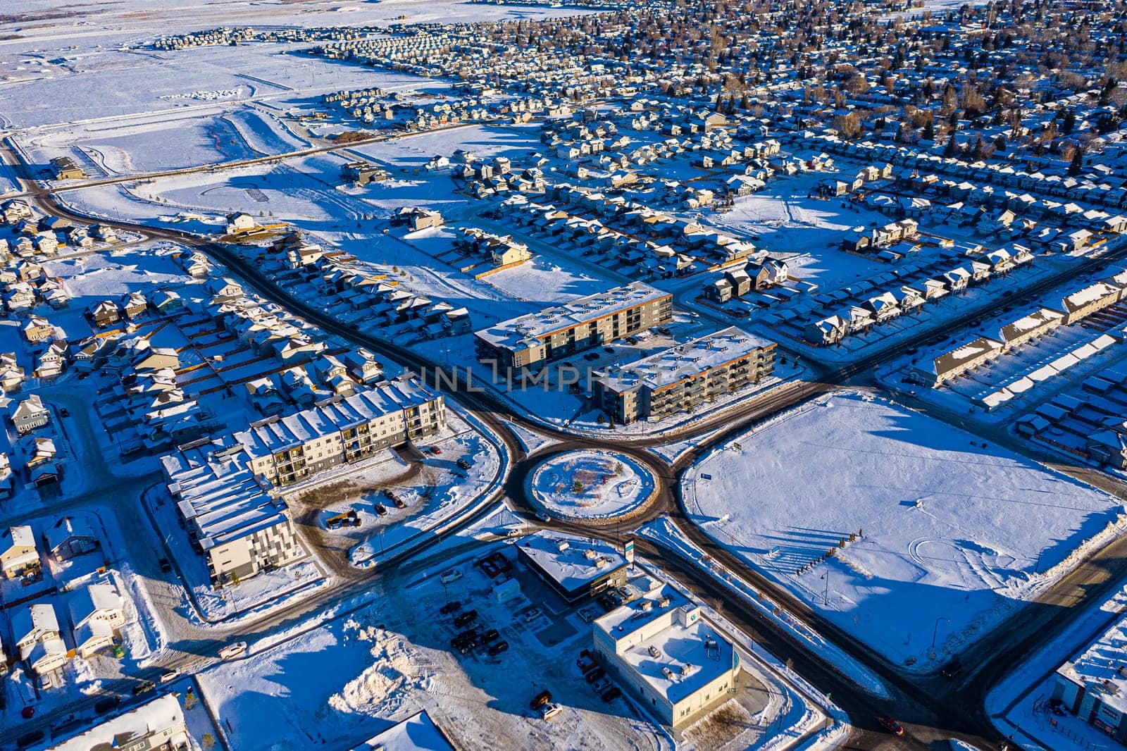 Discover Kensington in Saskatoon from a bird's-eye view. This drone image highlights the neighborhood's modern architecture, green spaces, and the lively, community-focused atmosphere.