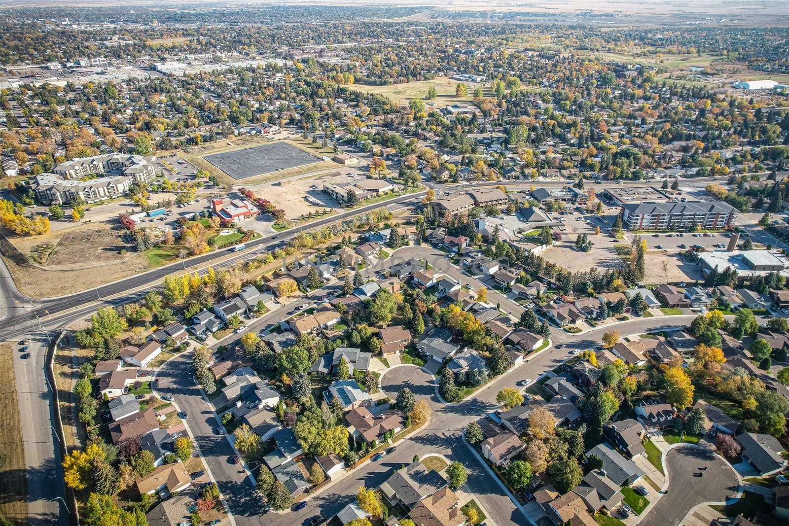 Soaring over Lakeview in Saskatoon, this bird's-eye capture magnifies the neighborhood's tranquil waters, verdant parks, and the serene rhythm of Saskatchewan living