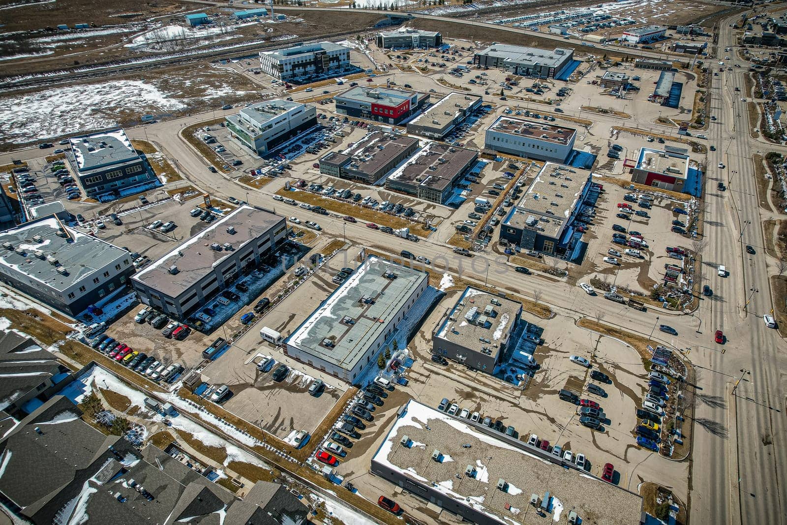 Captivating aerial shot of Stonebridge in Saskatoon, highlighting the harmonious blend of modern architecture and Saskatchewan's verdant surroundings.