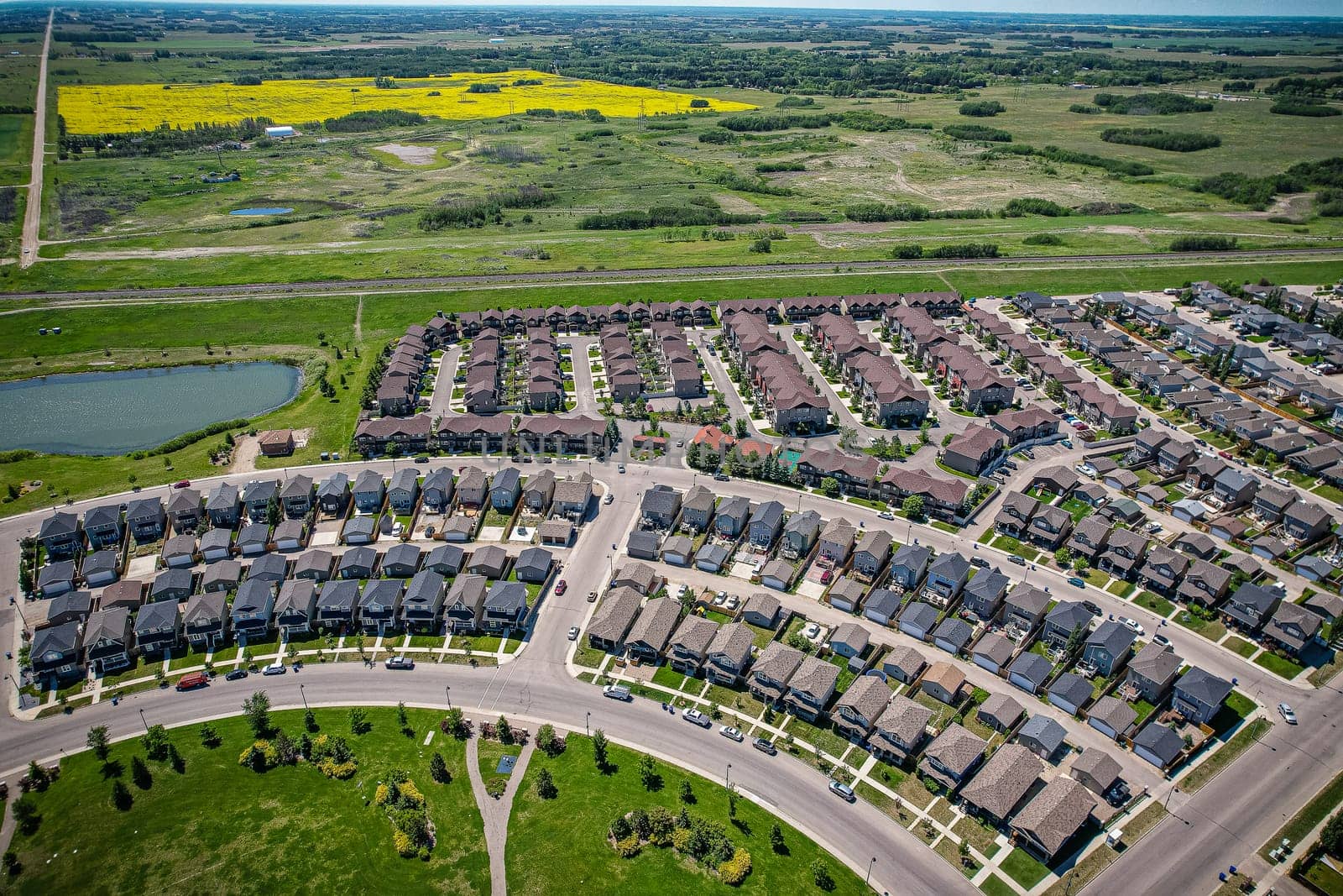 Captivating aerial shot of Stonebridge in Saskatoon, highlighting the harmonious blend of modern architecture and Saskatchewan's verdant surroundings.