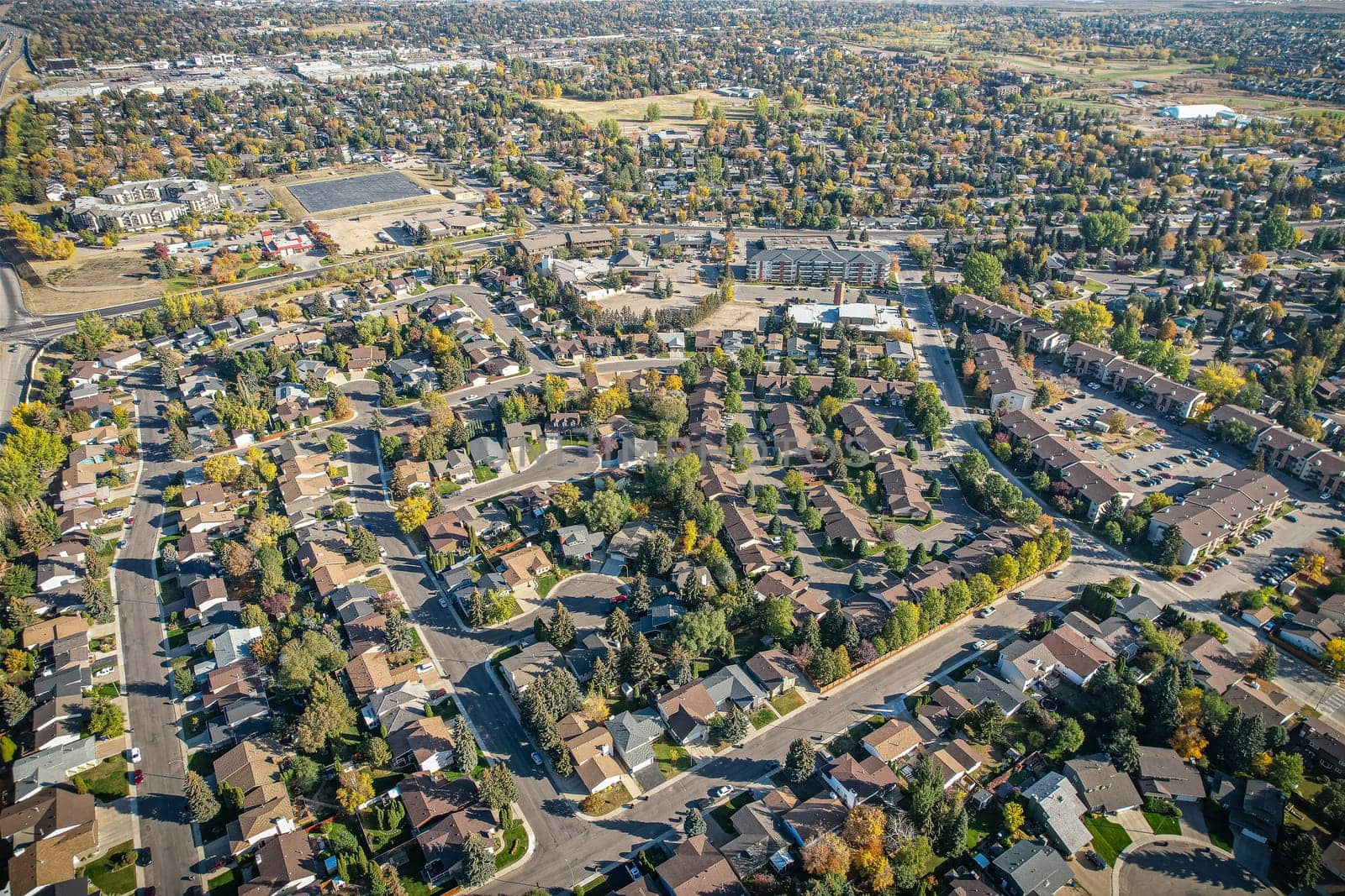 Soaring over Lakeview in Saskatoon, this bird's-eye capture magnifies the neighborhood's tranquil waters, verdant parks, and the serene rhythm of Saskatchewan living