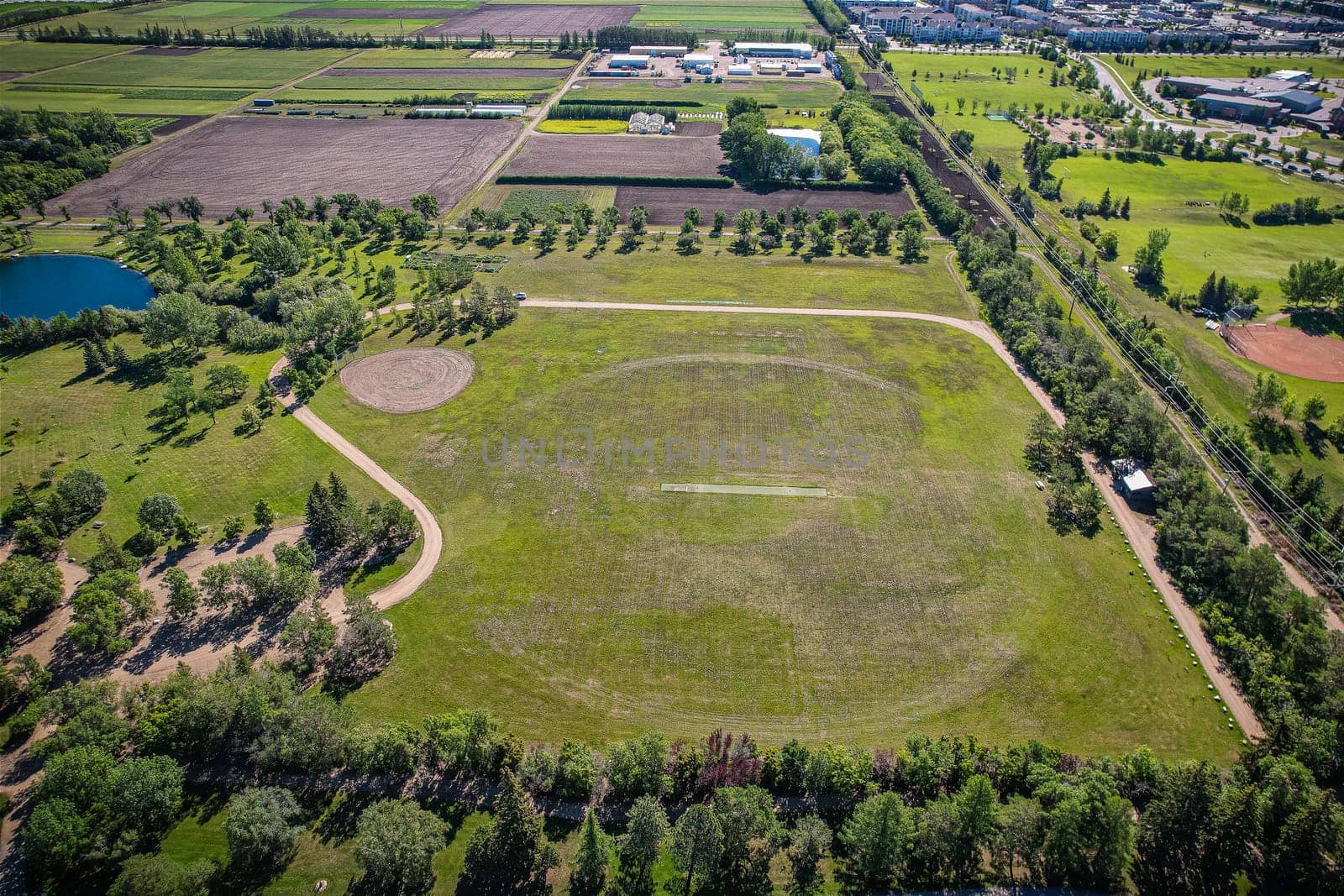 Aerial journey over Silverspring in Saskatoon, revealing a harmonious blend of suburban life, green expanses, and the distinct charm of Saskatchewan's landscapes.