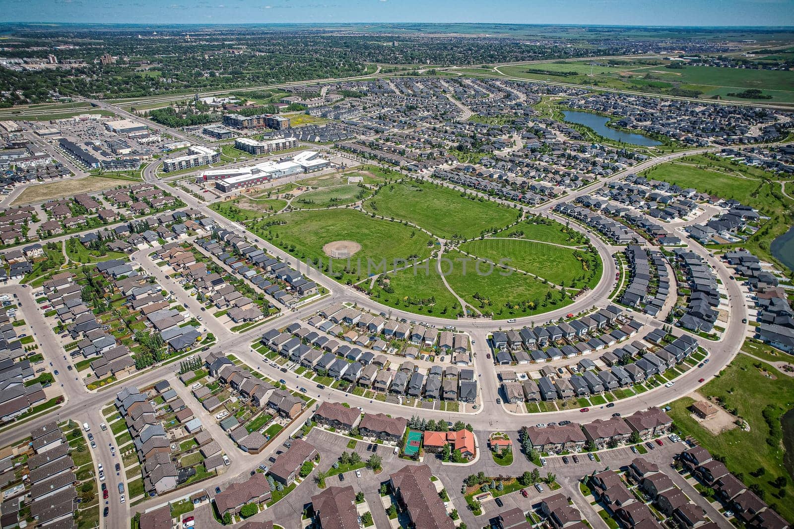 Captivating aerial shot of Stonebridge in Saskatoon, highlighting the harmonious blend of modern architecture and Saskatchewan's verdant surroundings.