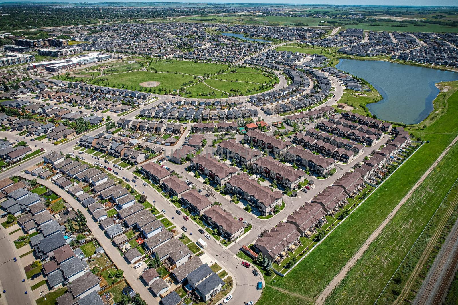 Captivating aerial shot of Stonebridge in Saskatoon, highlighting the harmonious blend of modern architecture and Saskatchewan's verdant surroundings.