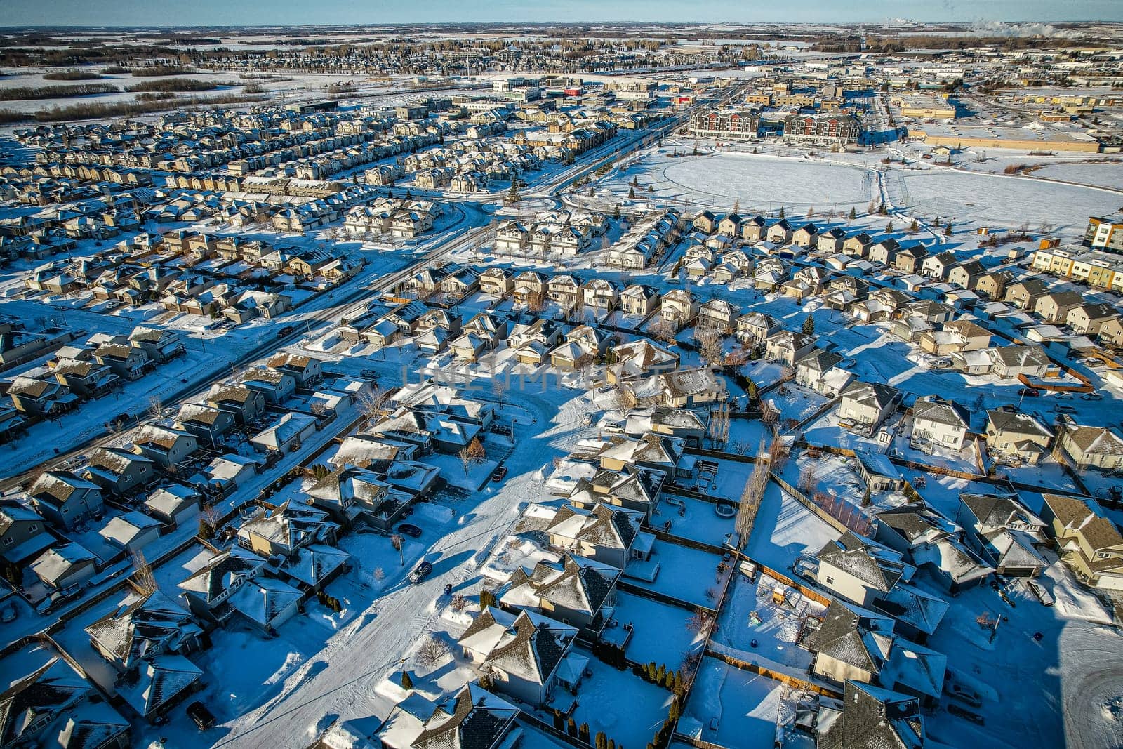 Captivating aerial shot of Stonebridge in Saskatoon, highlighting the harmonious blend of modern architecture and Saskatchewan's verdant surroundings.