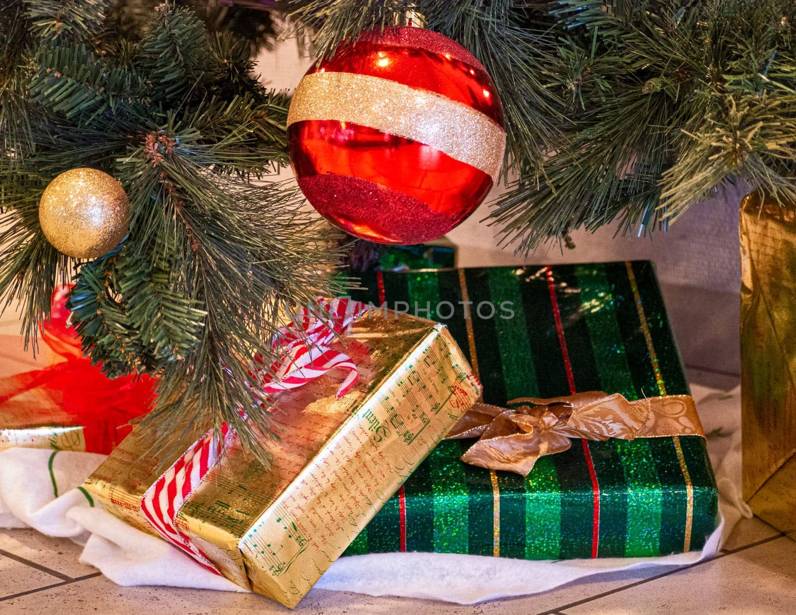Decorative Santa Claus sleigh with colored gifts boxes under christmas tree