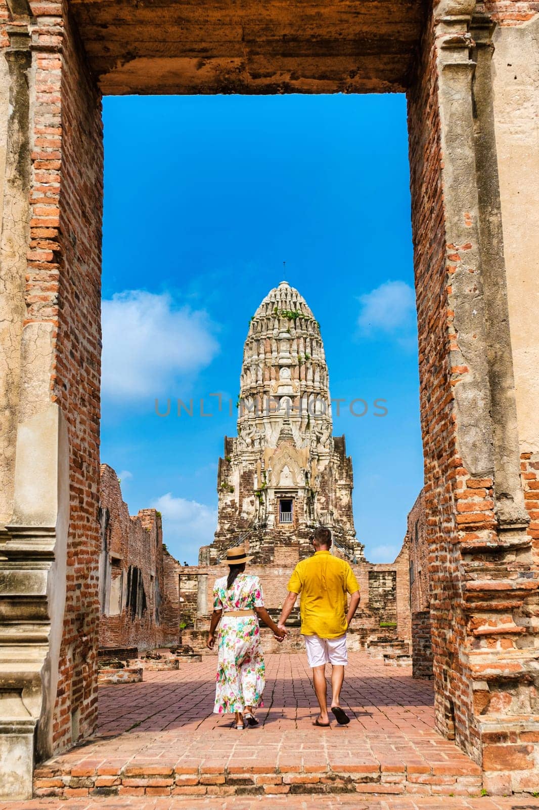 Ayutthaya, Thailand at Wat Ratchaburana, a couple of men and women with a hat visiting the historical city of Ayutthaya Thailand.