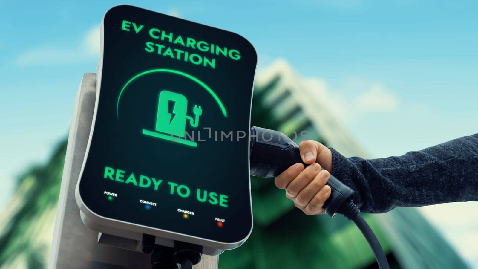 Businessman pull EV charger to recharge his electric car's battery from charging station in green eco city park background. Future innovative EV car and energy sustainability. Peruse