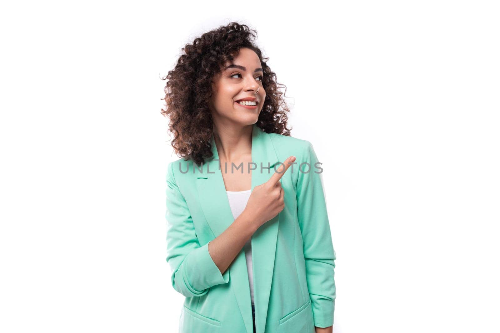 young leader woman with curly black hair dressed in jacket smiling isolated on white with copy space by TRMK