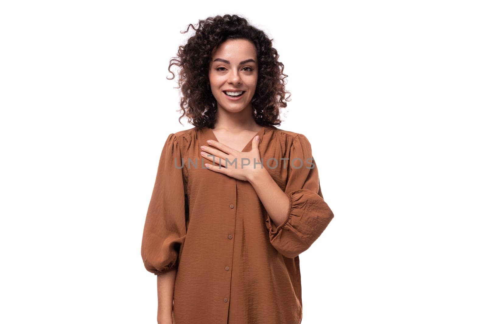 young fashionista curly brunette woman dressed in a stylish brown blouse.