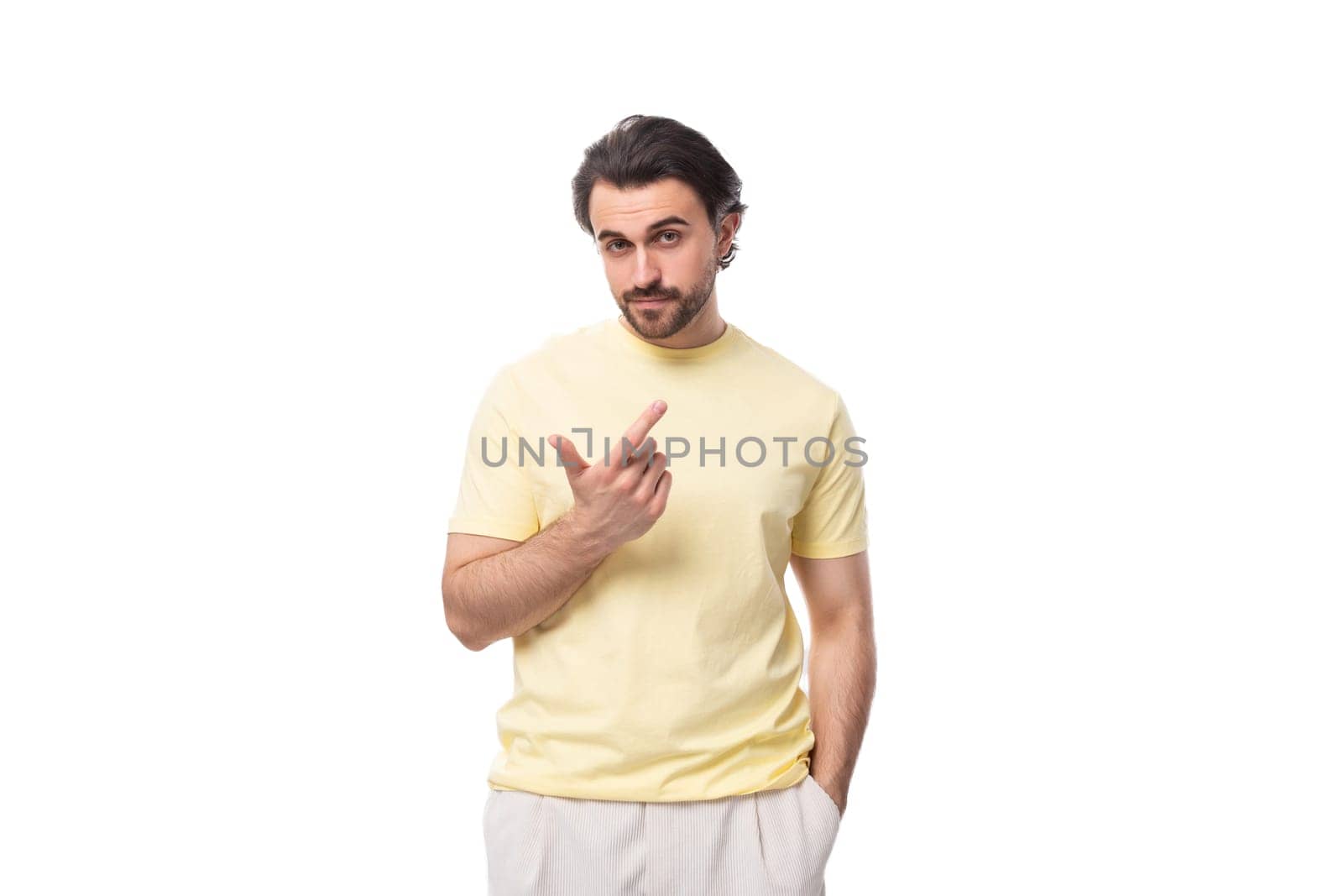 portrait of a young stylish brunette european man with a beard and mustache dressed in a summer t-shirt by TRMK