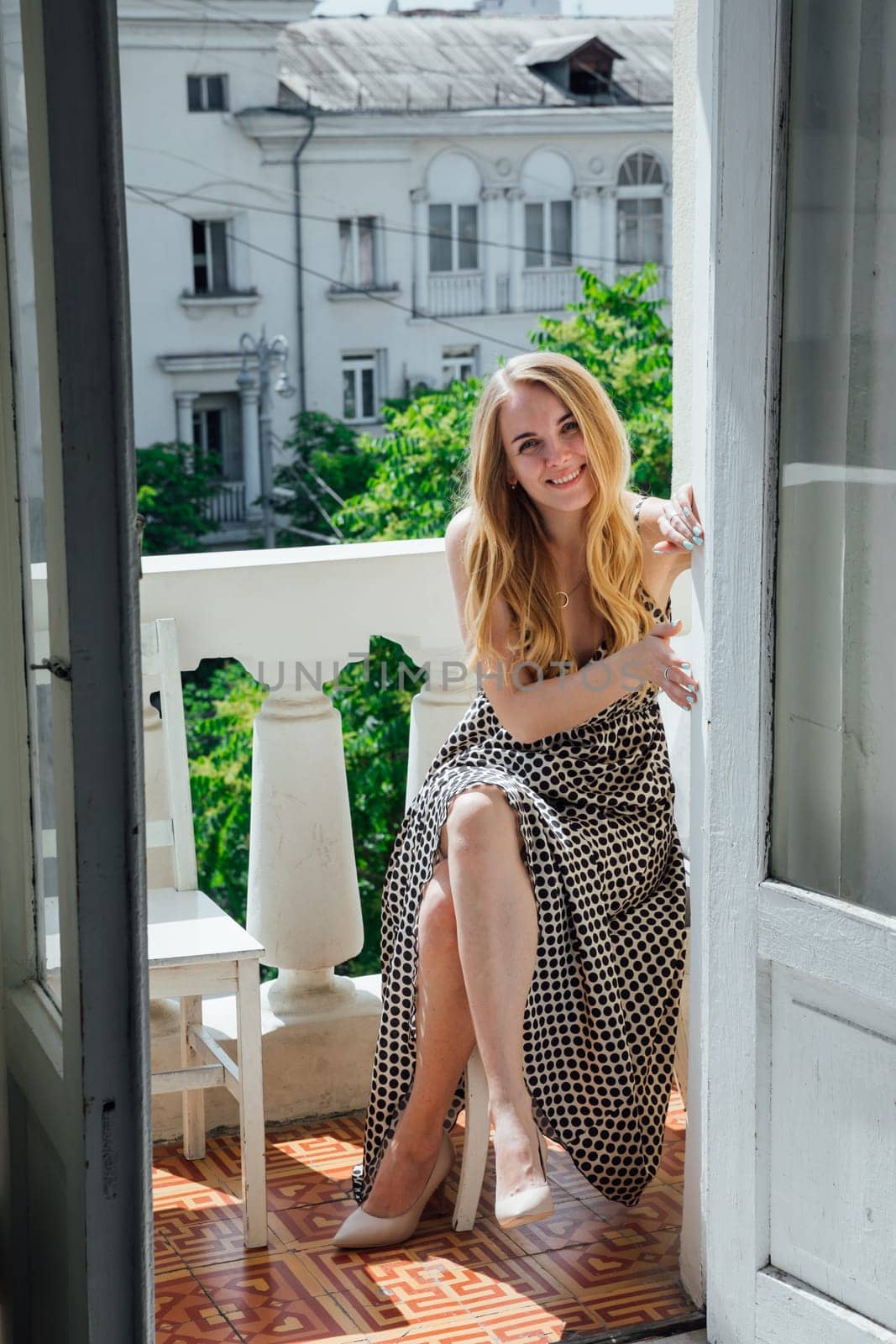Portrait of beautiful fashionable blonde woman in light summer dress by Simakov