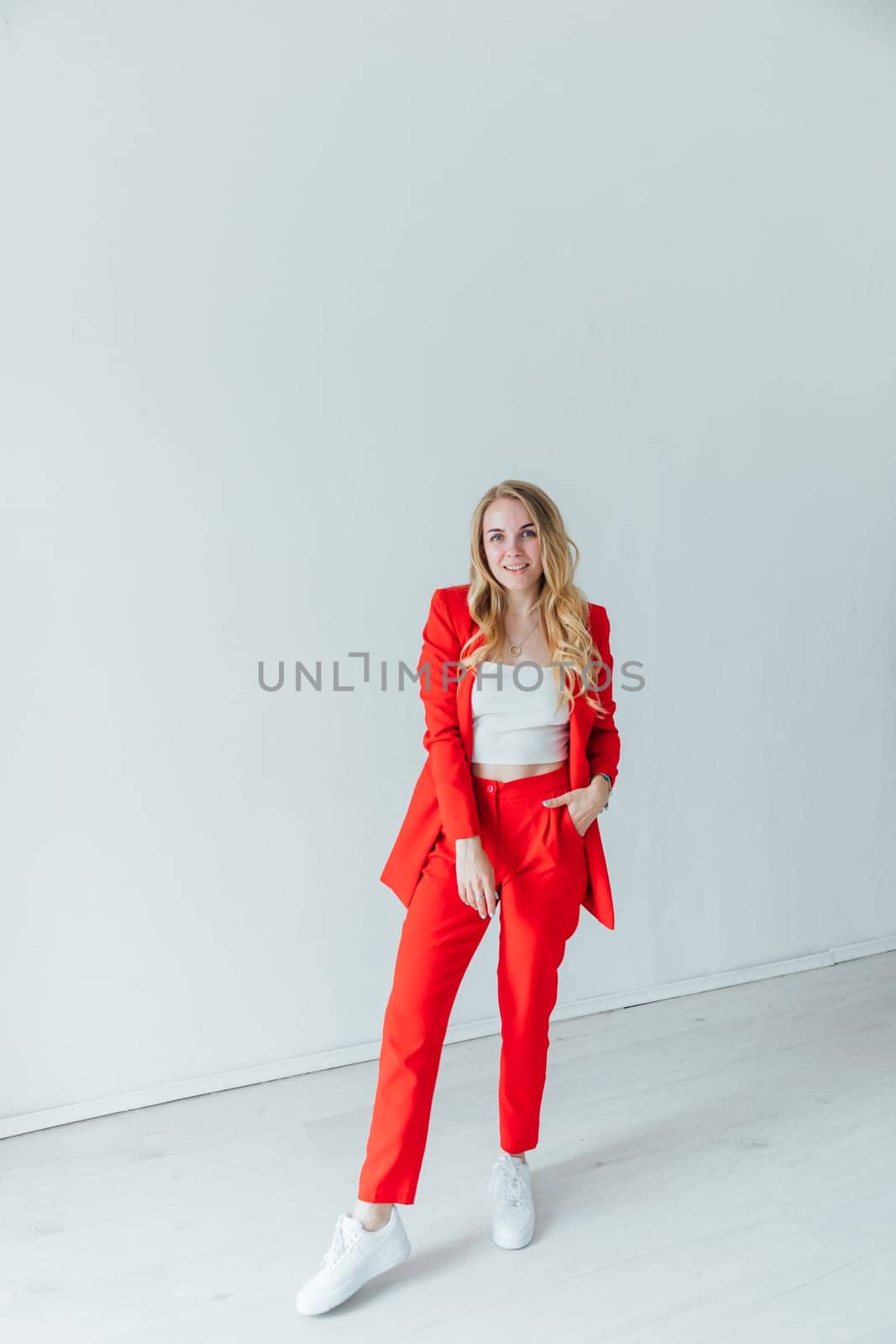 Beautiful blonde woman in red business suit
