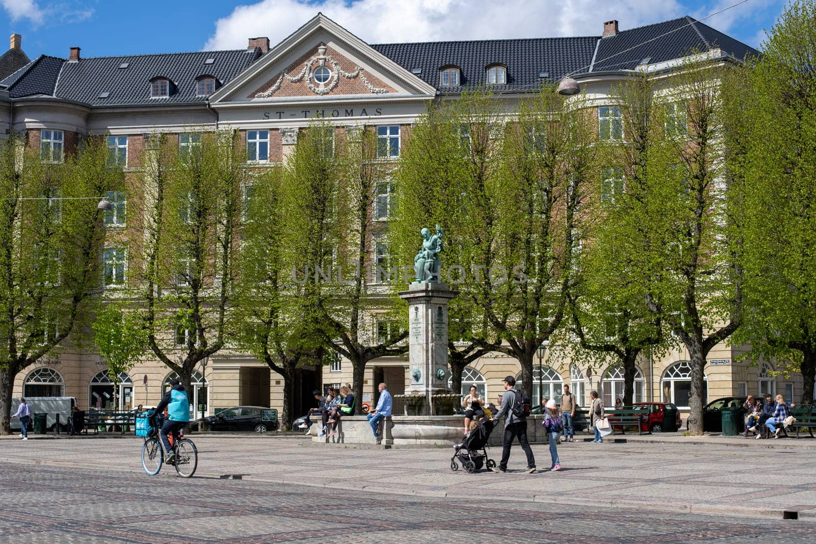 Frederiksberg, Denmark - May 7, 2022: Historic fountain and people on Sankt Thomas Plaza.