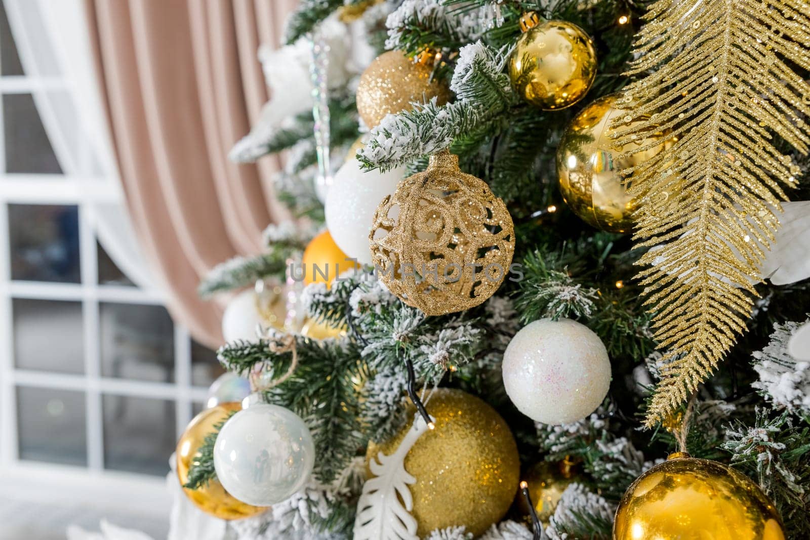 The interior of a room decorated for the holiday. Christmas New Year tree with garlands