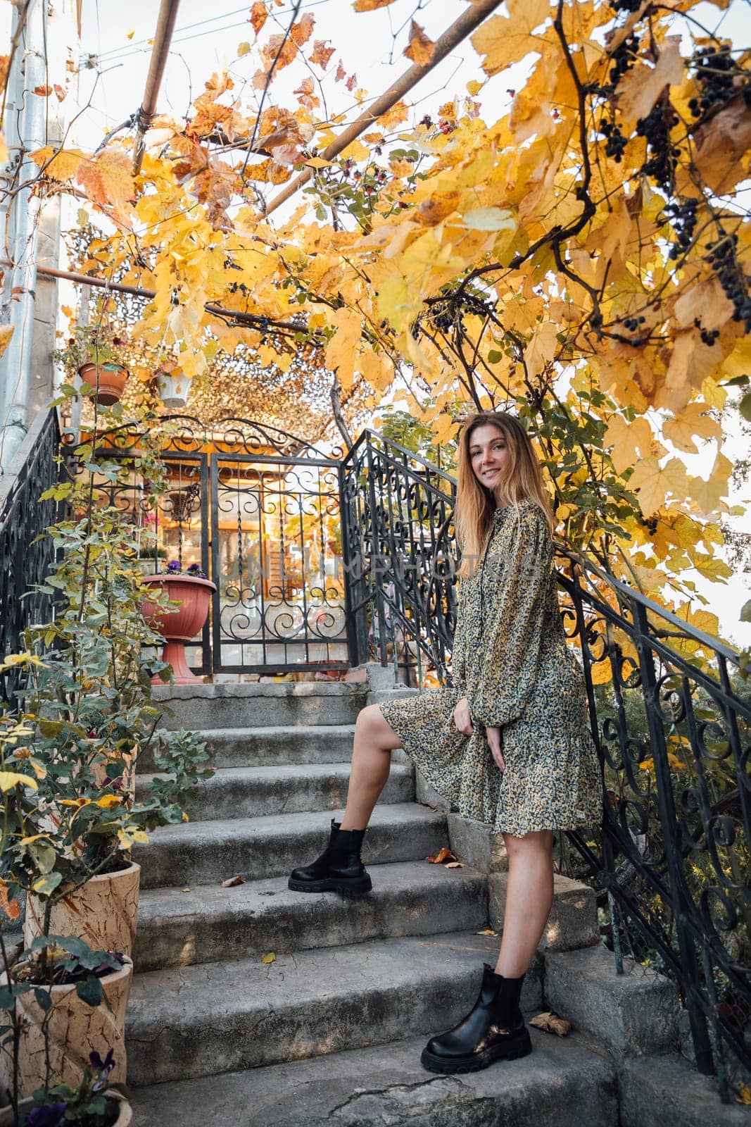 Beautiful fashionable slender woman walking on autumn yellow streets by Simakov