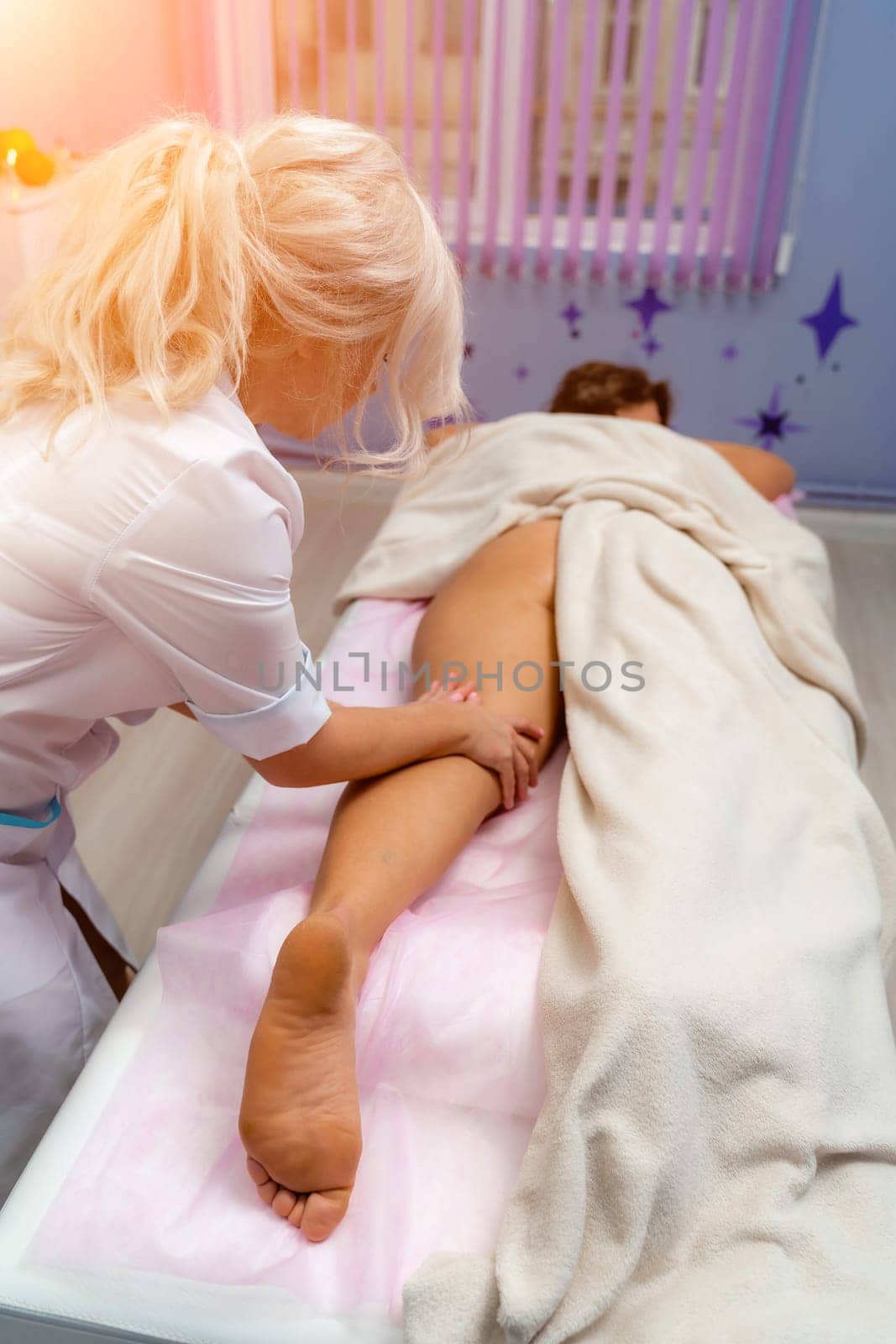 Facial massage. A woman is given a massage in a beauty salon. Close-up