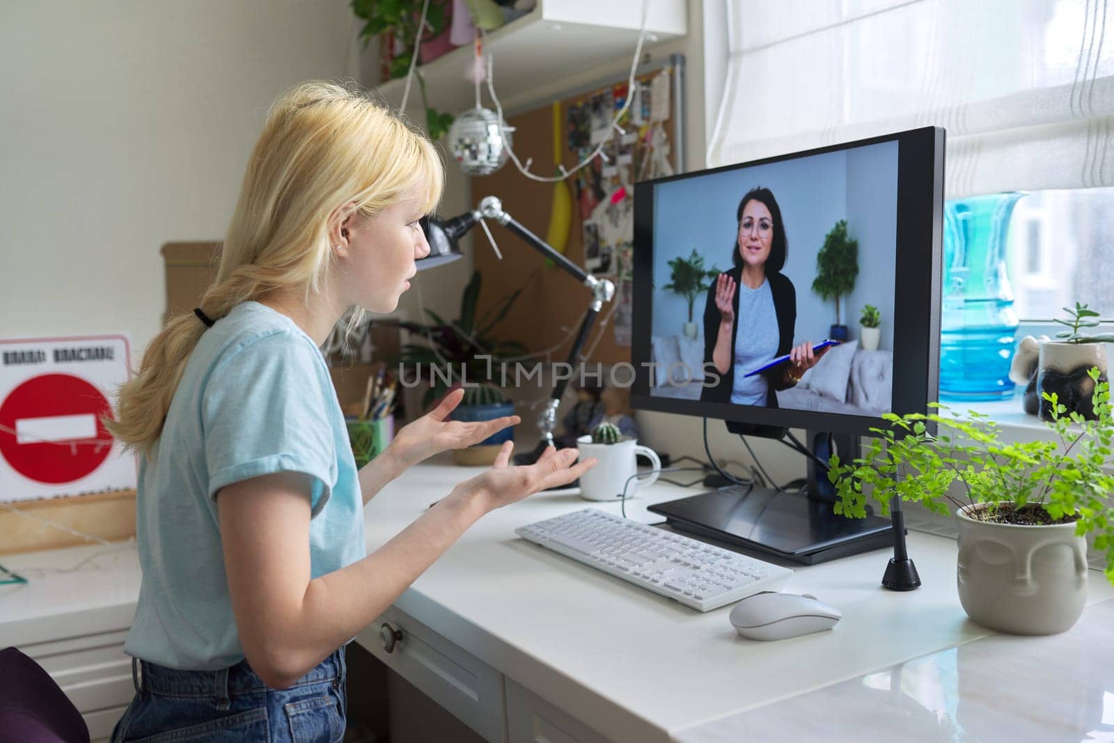Online session of teenage girl and psychologist, social worker. Young female talking to therapist, teacher, at home looking at computer screen. Professional help, mental health, education, adolescence