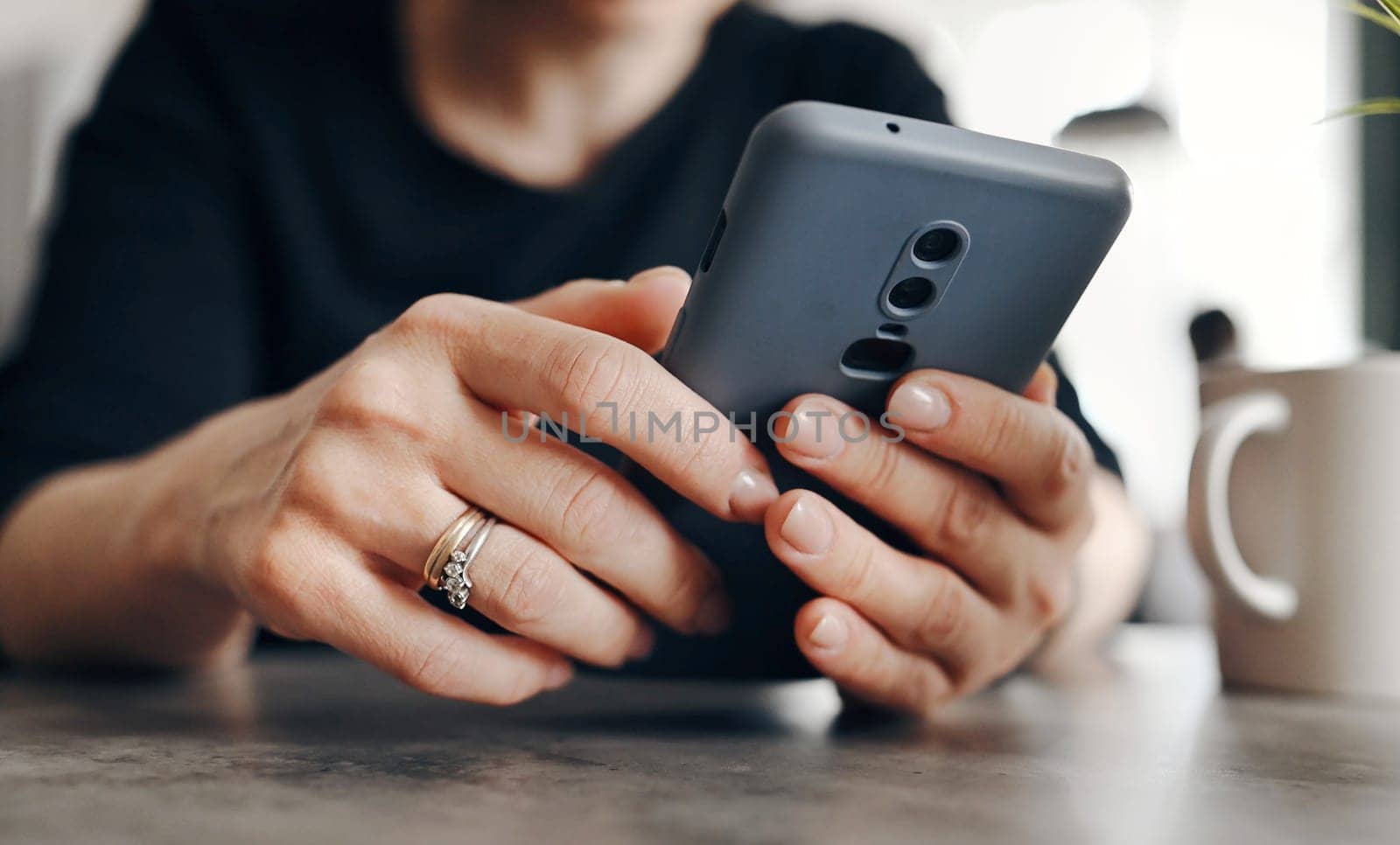 Young Woman Using A Smartphone Surfing On The Internet And Smiling by GekaSkr