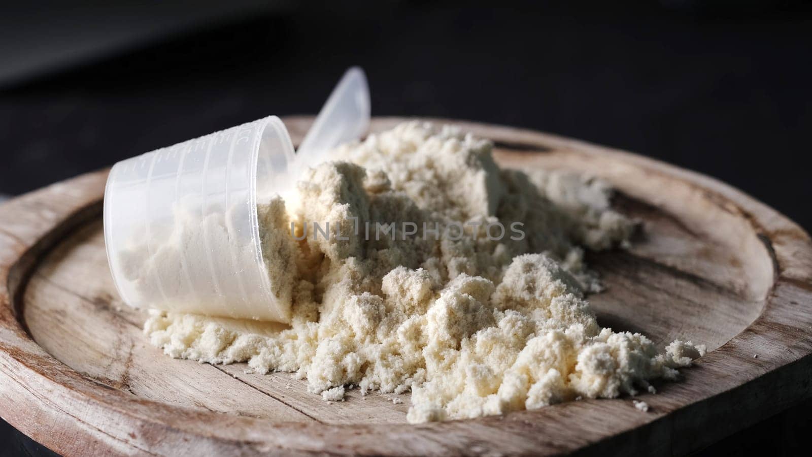 Scoop with whey protein powder on board, supplements for bodybuilding and healthy body