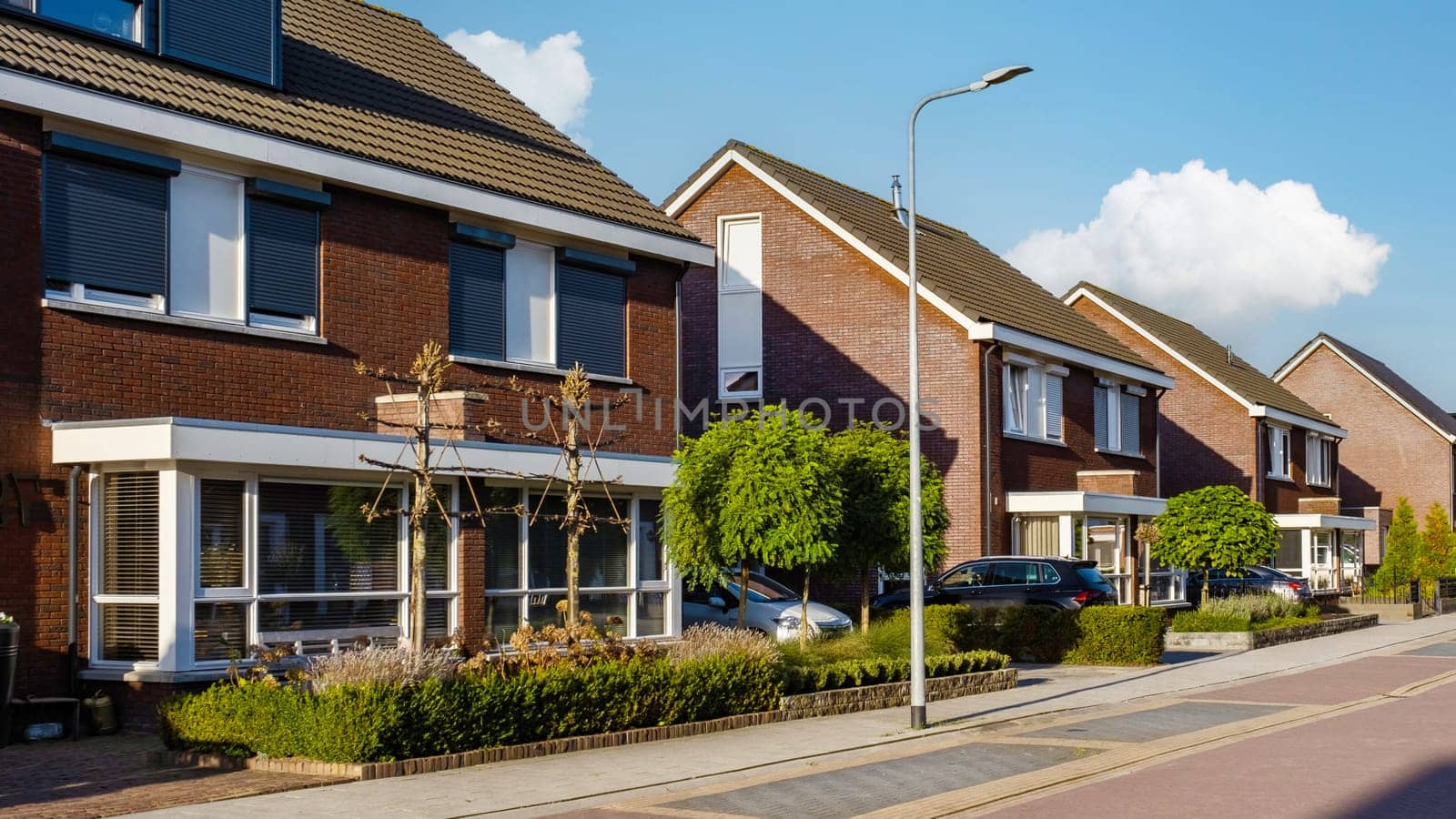 Dutch Suburban area with modern family houses, newly built modern family homes in the Netherlands, Row of modern houses in a family friendly suburban neighborhood