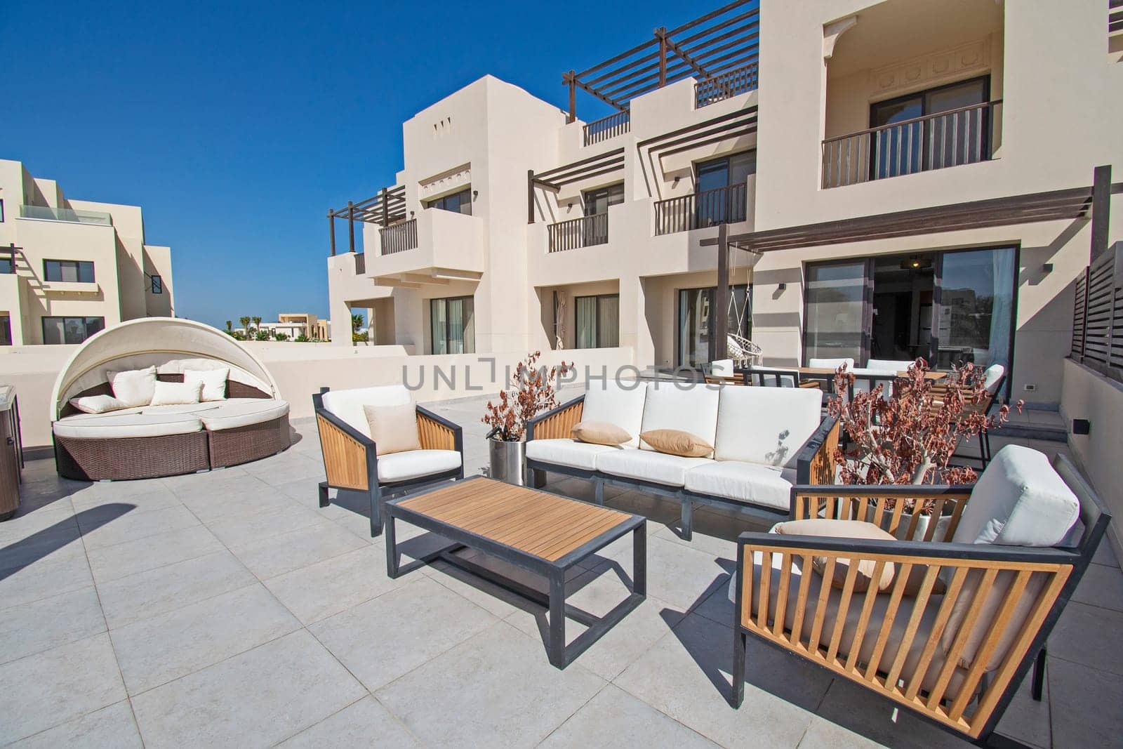 Roof terrace patio furniture at a luxury holiday villa in tropical resort with table and chairs