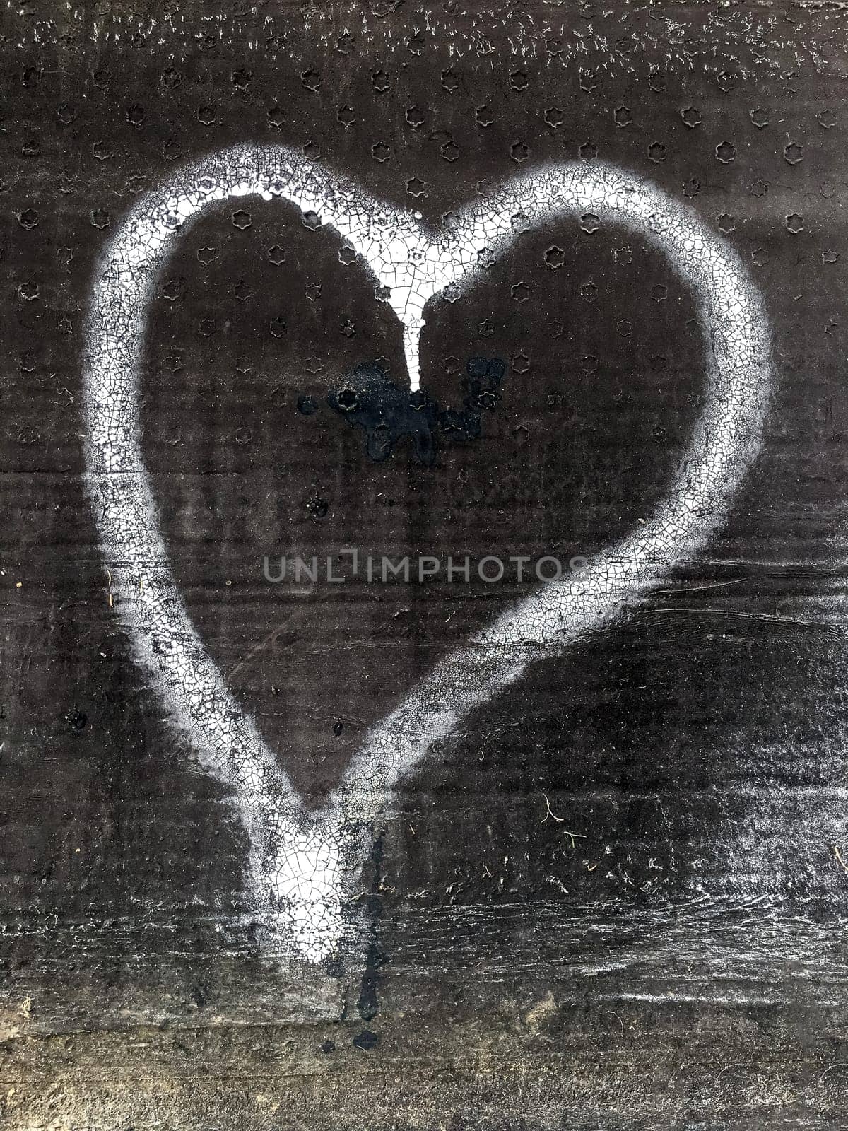 White heart painted on grunge background. Concepts and holiday.