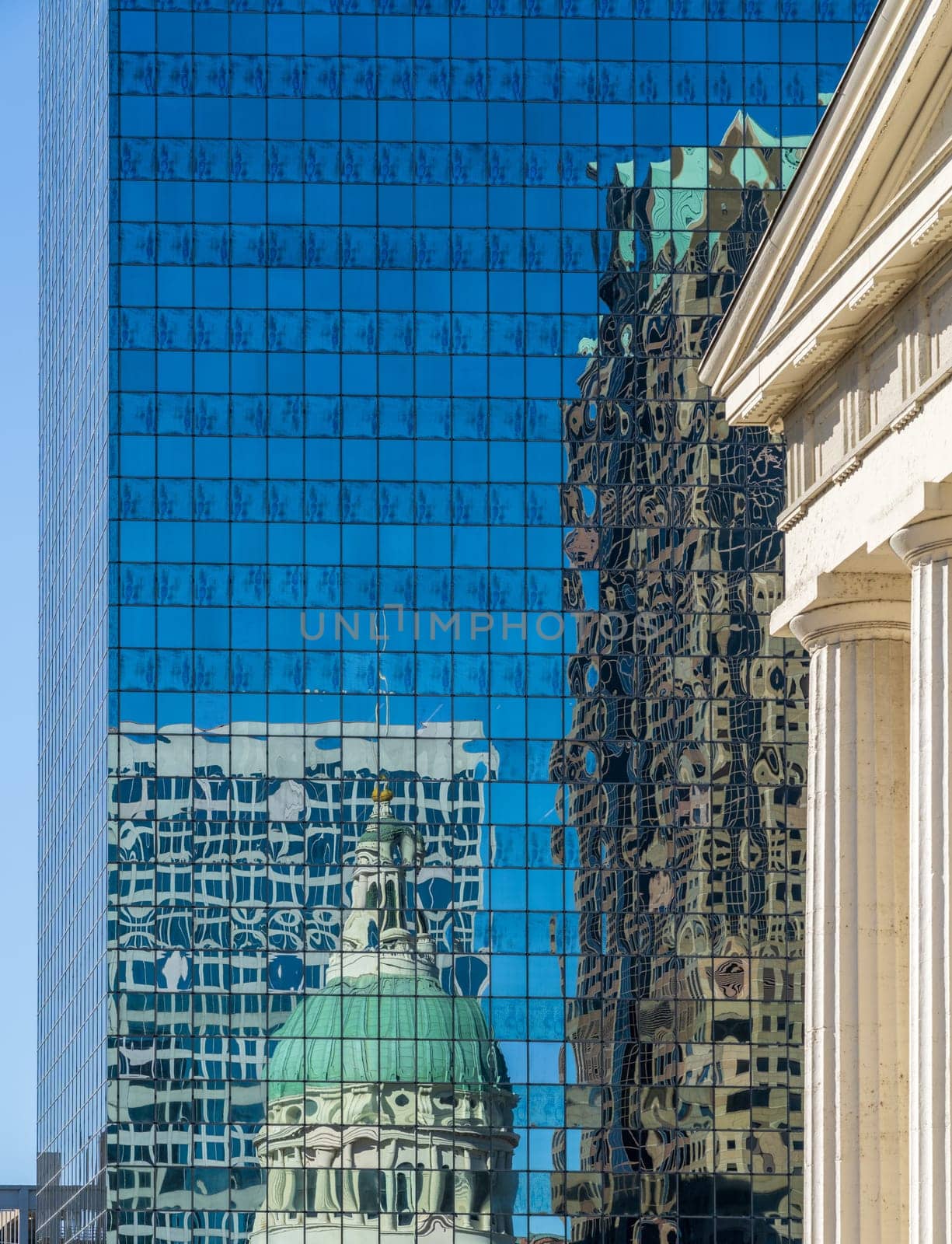 Reflections of Old Courthouse and modern office skyscraper in a mirrored building in downtown St Louis in Missouri