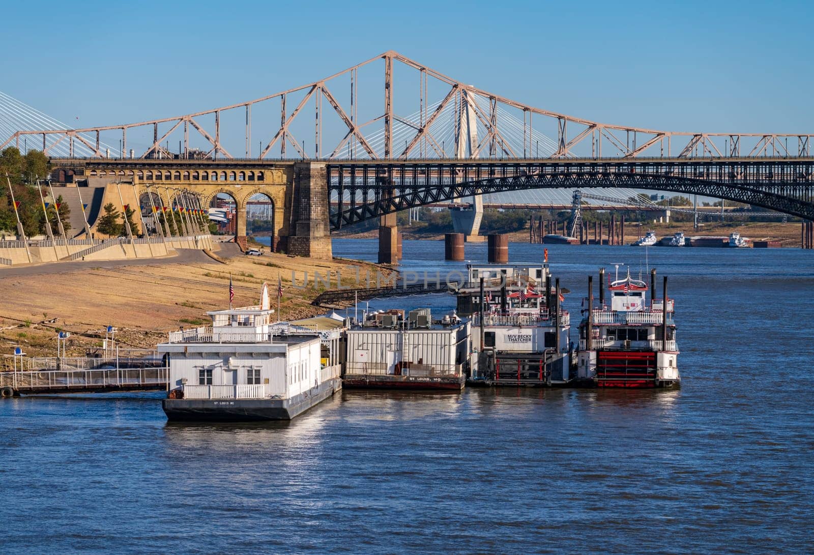 St Louis, MO - 21 October 2023: Low water levels in Mississippi river with casino riverboats docked by riverbank
