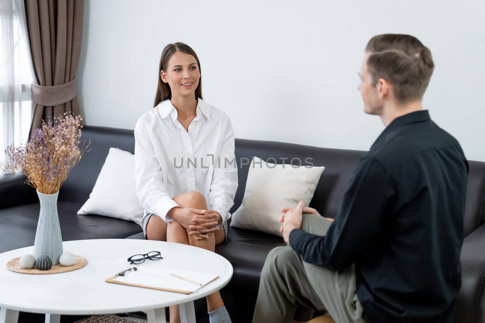 Psychological consultation gaining improvement on mental problem, happy young female patient doing therapy session while psychiatrist making diagnostic on mental illness. Unveiling