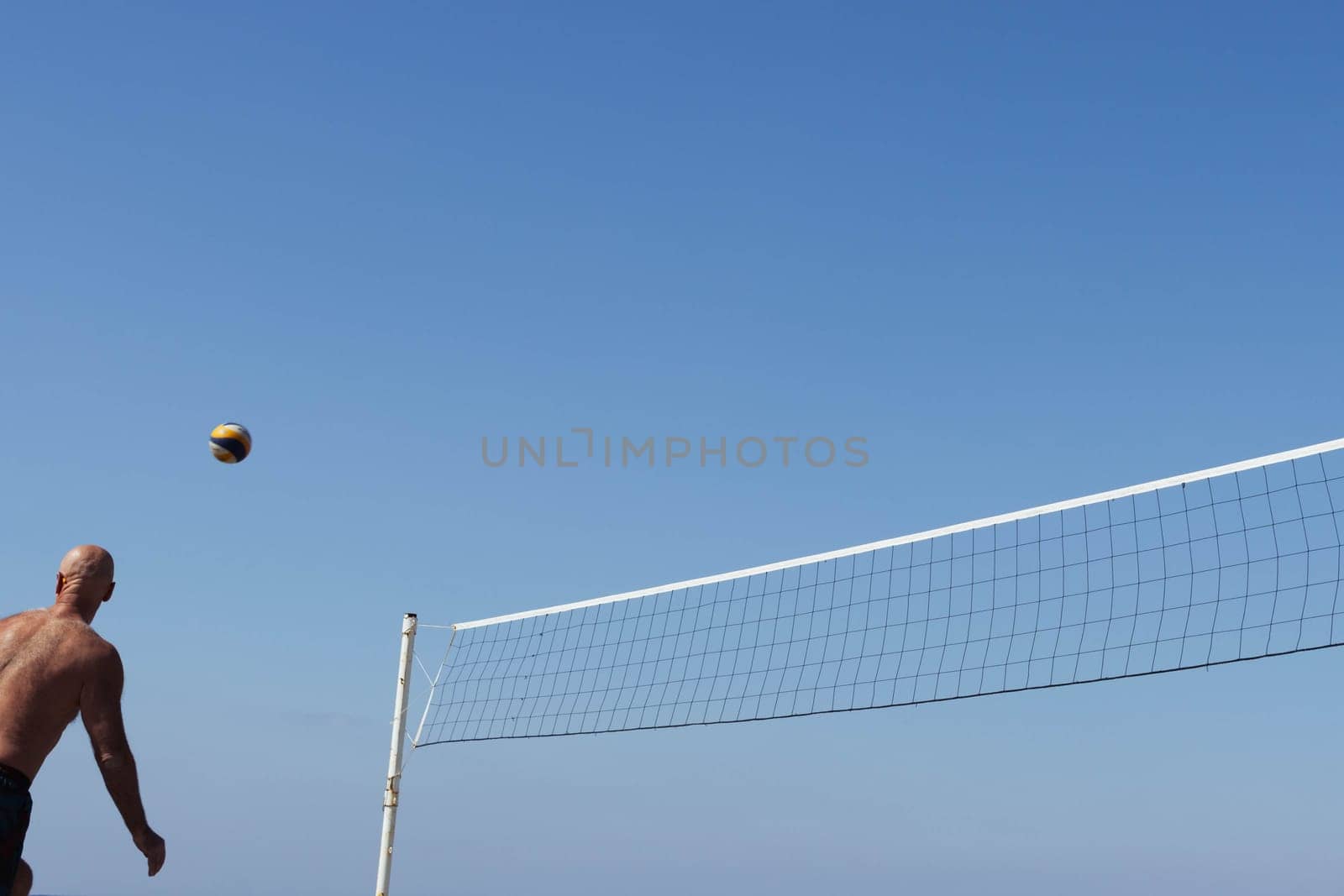 Turkey, Mahmutlar March 20, 2022 playing volleyball on the street blue sky there is a place for an inscription, background. High quality photo