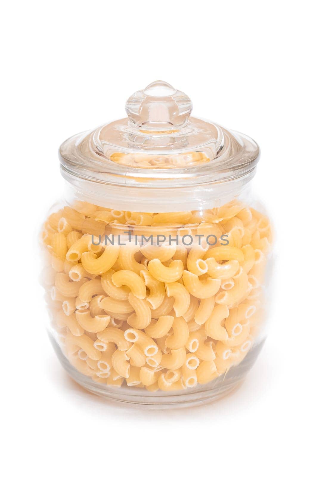 Uncooked Chifferi Rigati Pasta in Glass Jar Isolated on White by InfinitumProdux