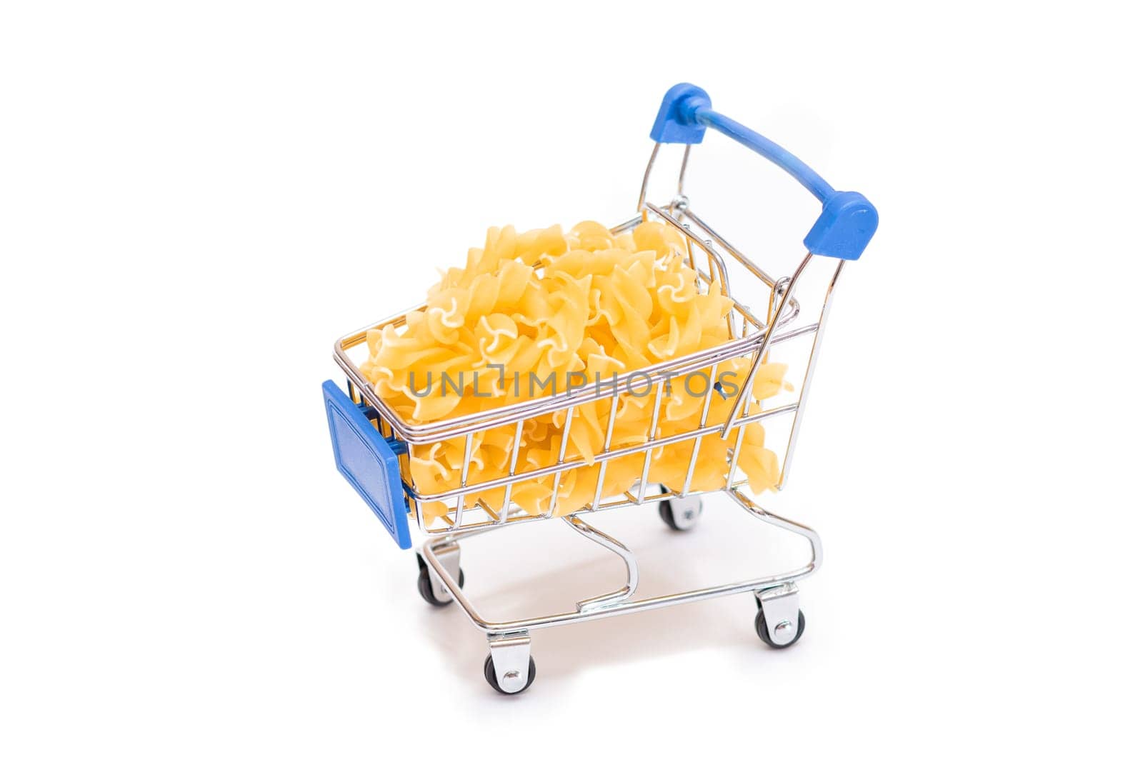 Uncooked Fusilli Pasta in Small Shopping Cart Isolated on White Background. A Crisis: Buying Cheap Food. Classic Dry Spiral Macaroni. Italian Culture and Cuisine. Raw Pasta - Isolation