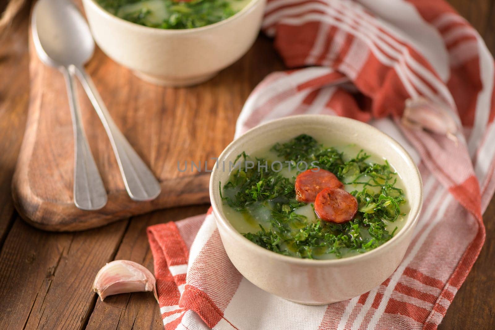 Caldo verde popular soup in Portuguese cuisine. traditional ingredients for caldo verde are potatoes, collard greens , olive oil and salt. Additionally garlic or onion may be added.