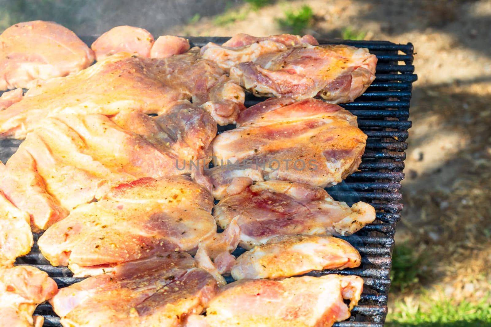 Raw steak on a charcoal barbeque. Top view of camping tasty barbecue, food concept, food on grill and detail of food on the grill