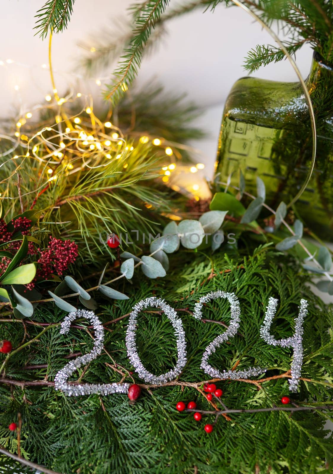 2024 new year green background from live leaves and branches. Seasonal packaging and New Year's paraphernalia. New Year's composition, a ready-made opening