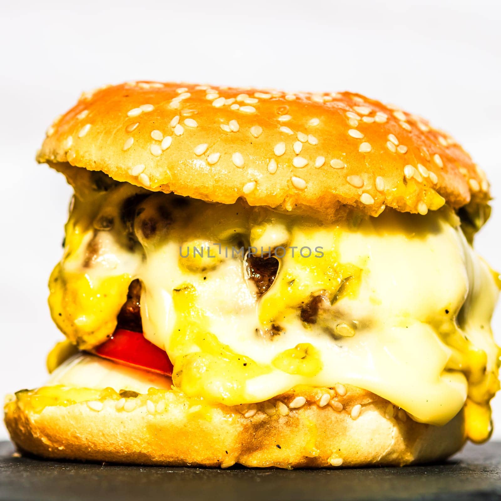 Tasty home made cheeseburger. Cheese burger with pickles, tomatoes, onion, melting cheese