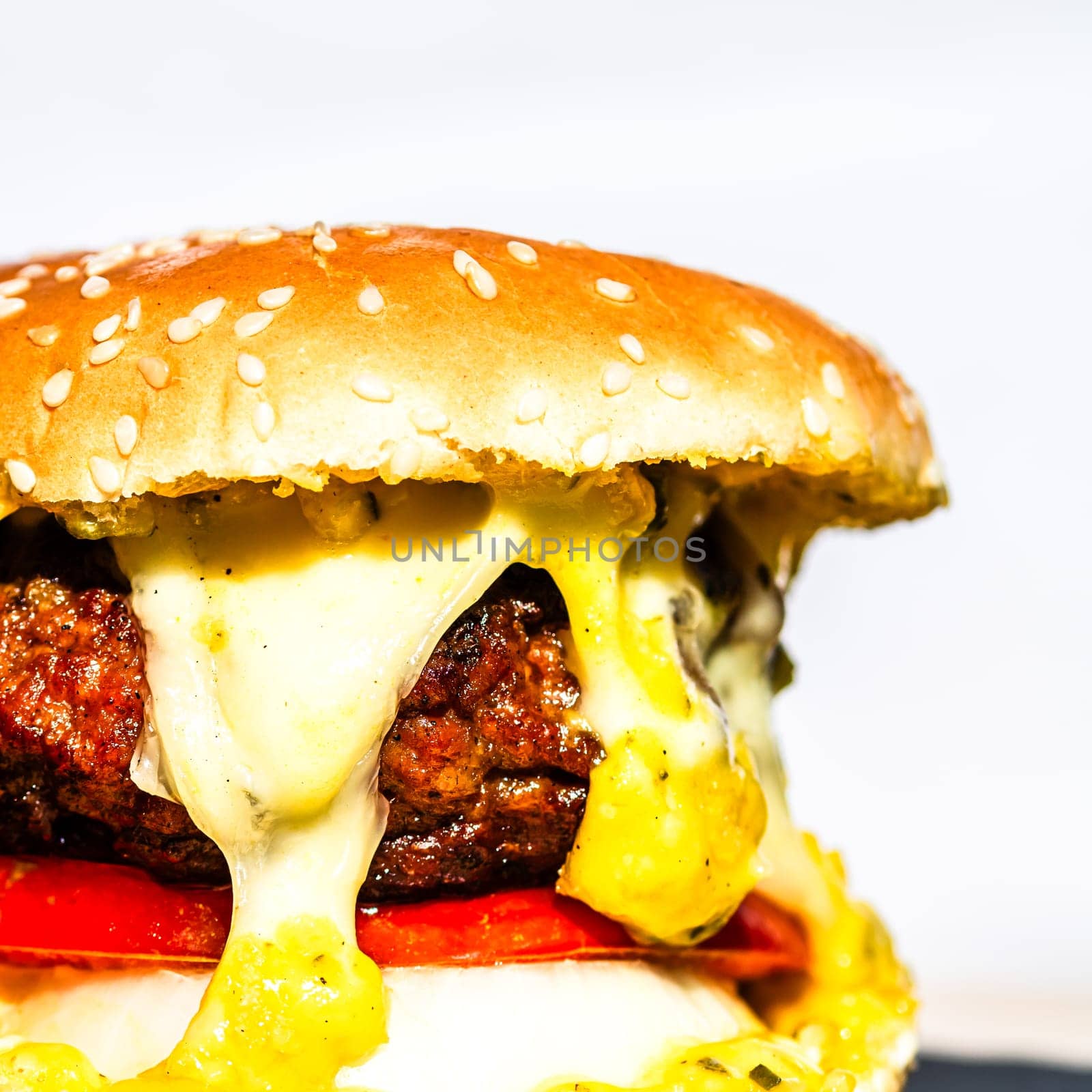 Tasty home made cheeseburger. Cheese burger with pickles, tomatoes, onion, melting cheese