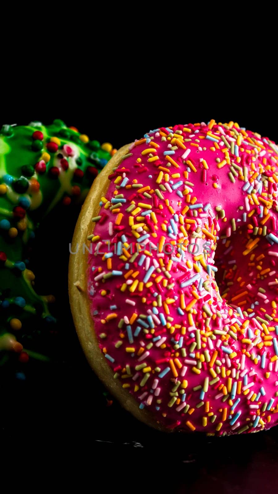  Glazed donuts with sprinkles isolated. Close up of colorful donuts. by vladispas