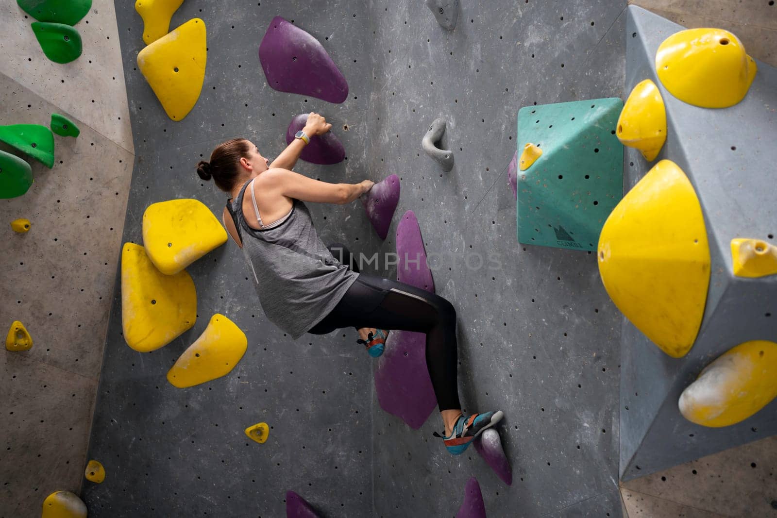 Mature woman climbs an exercise mountain at gym by andreonegin