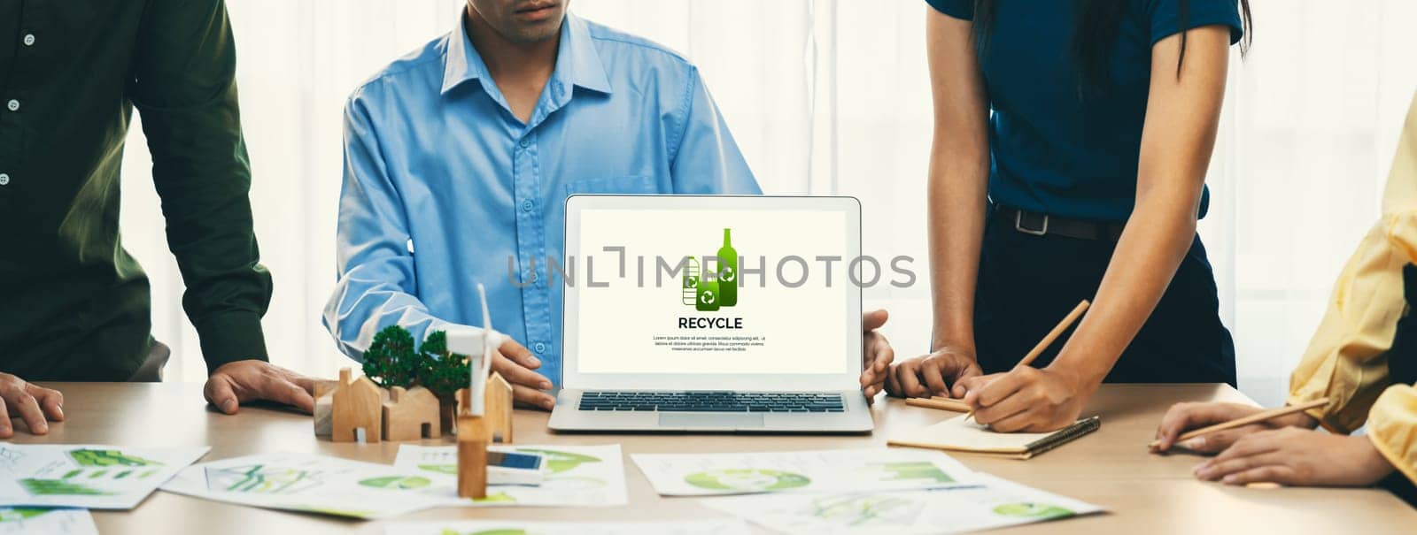 Recycle packaging displayed on laptop at a green business meeting while business team presenting green design. ESG environment social governance and Eco conservative concept. Closeup. Delineation.