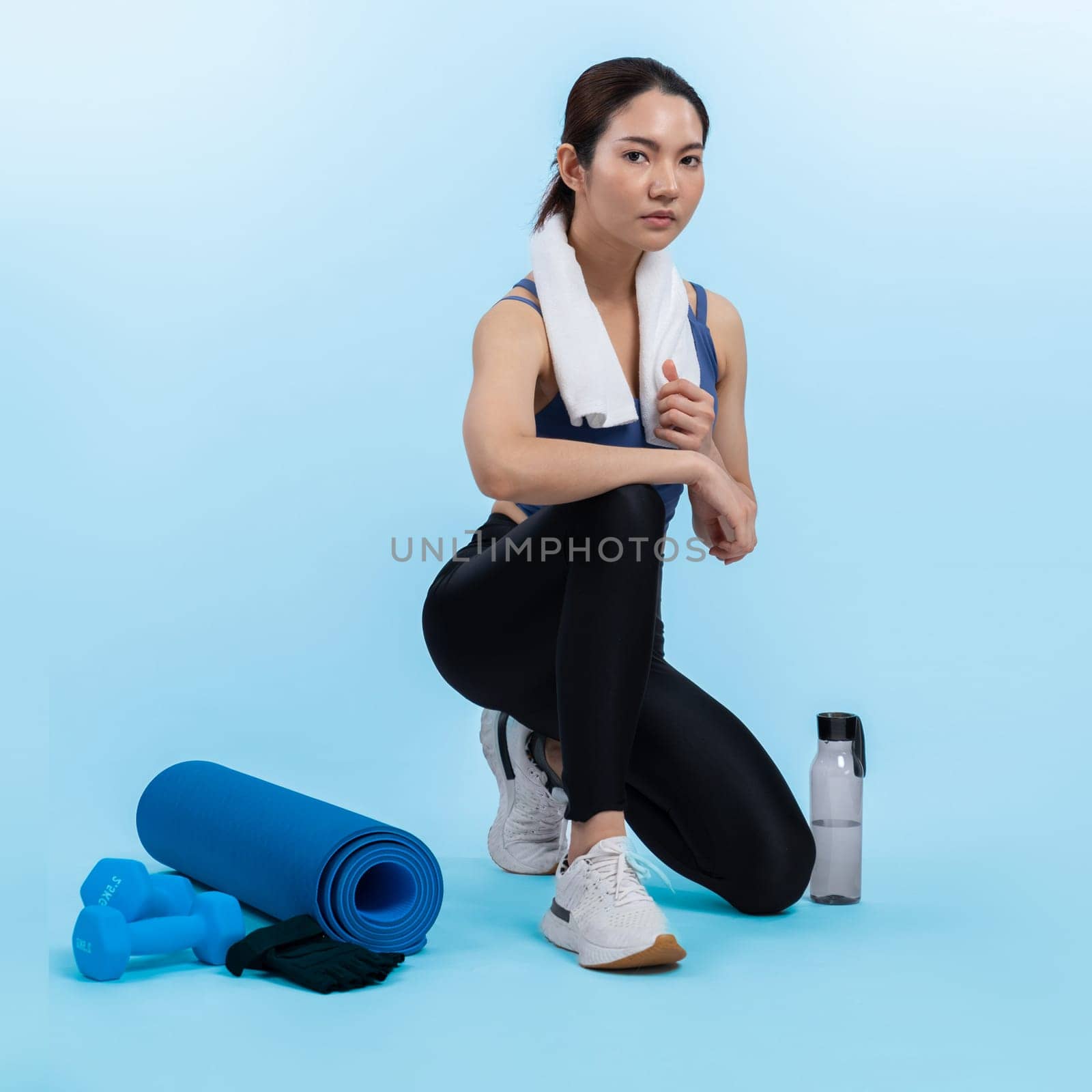 Athletic and sporty asian woman resting after intensive cardio workout training. Healthy exercising and fit body care lifestyle pursuit in studio shot isolated background. Vigorous