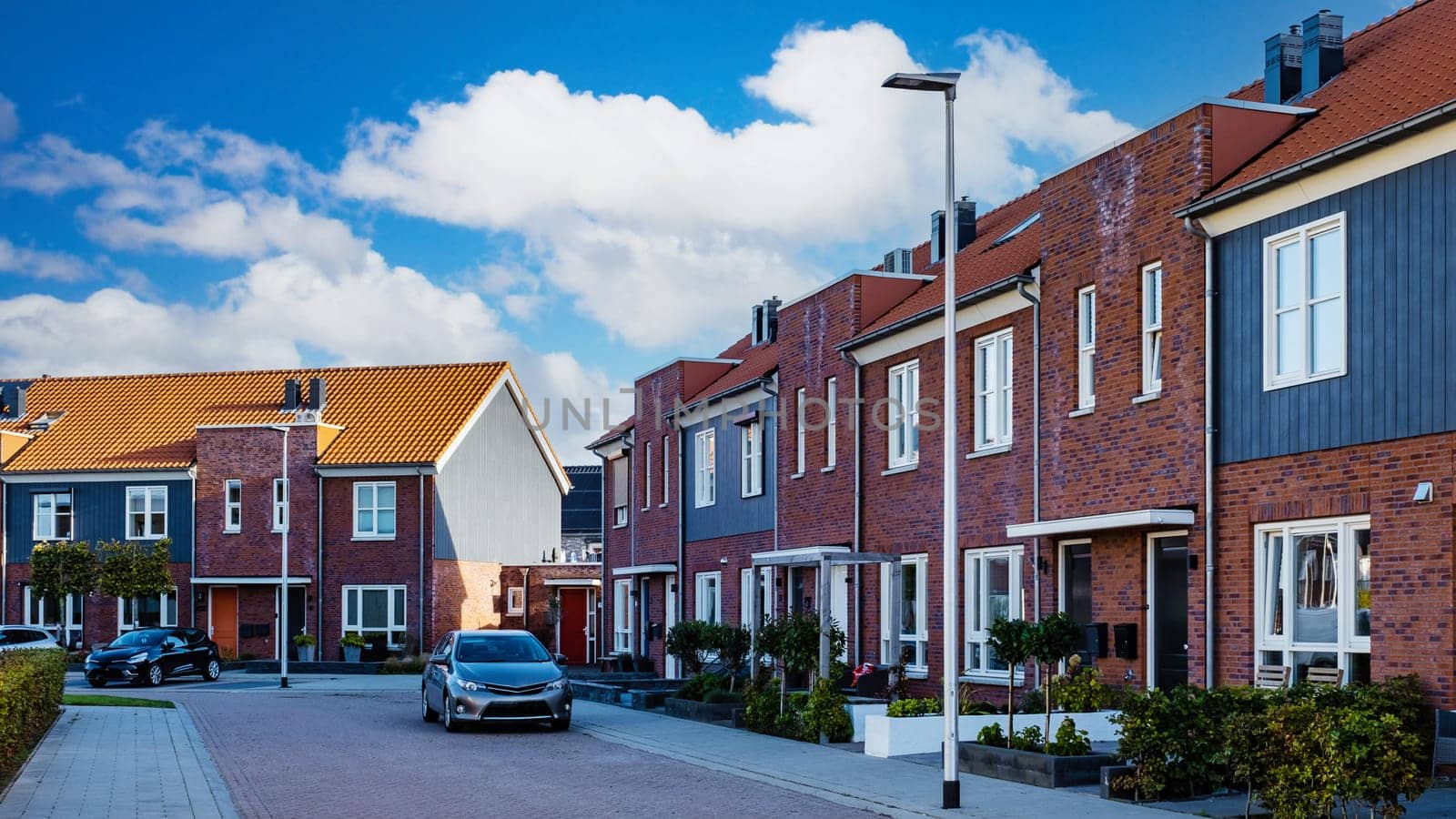 Dutch Suburban area with modern family houses, street with modern family homes in the Netherlands