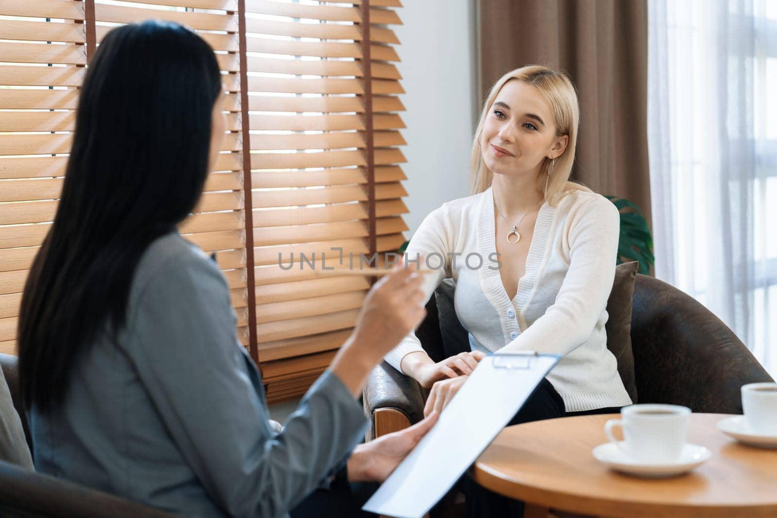 Psychological consultation gaining improvement on mental problem, happy young female patient getting better during therapy session while psychiatrist making diagnostic on mental illness. Blithe