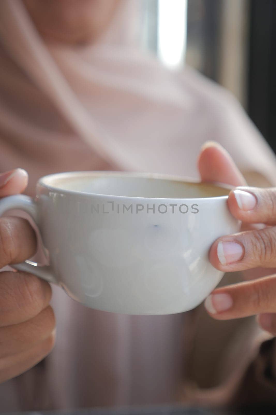 women holding a coffee cup .