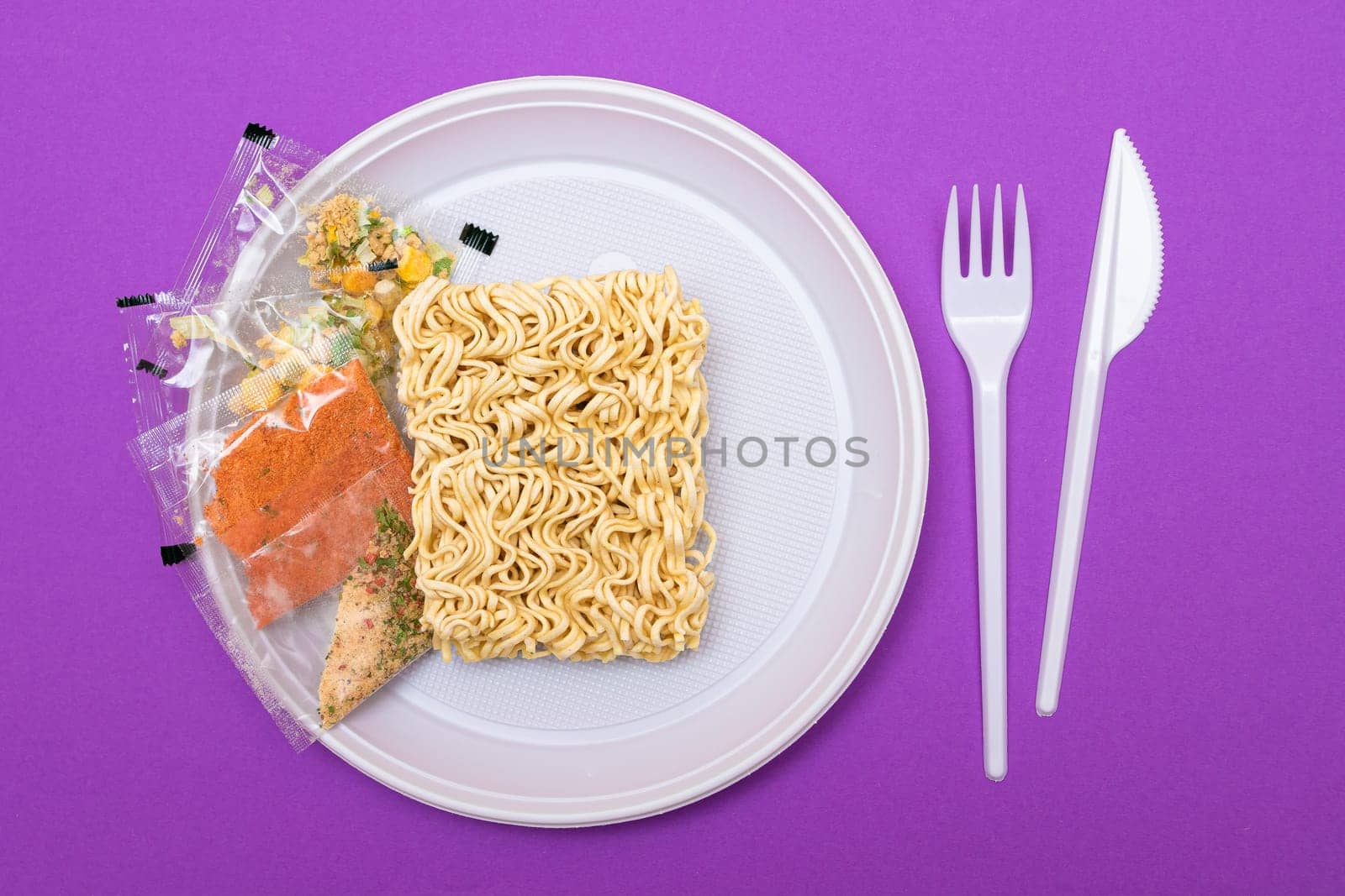 Uncooked Instant Noodles on White Plate. Raw Pasta. Dry Asian Fast Food. Quick Lunch