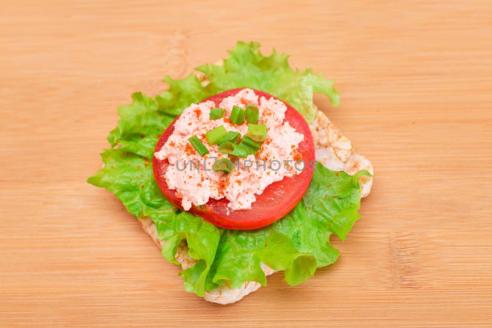 Rice Cake Sandwich with Tomato, Lettuce, Fish Cream and Green Onions on Bamboo Cutting Board. Easy Breakfast. Quick and Healthy Sandwiches. Crispbread with Tasty Filling. Healthy Dietary Snack