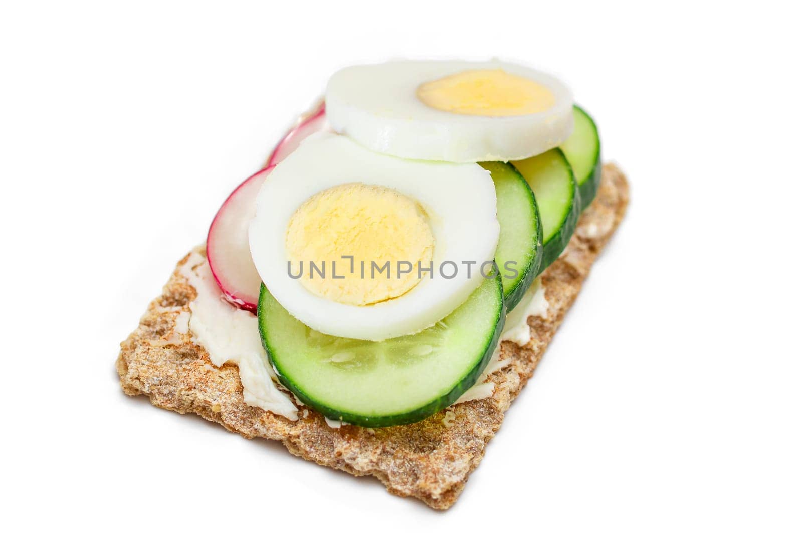 Whole Grain Crispbread with Fresh Cucumber, Egg, Cream Cheese and Radish - Isolated on White. Quick and Healthy Sandwiches. Crispbread with Tasty Filling. Healthy Dietary Snack - Isolation