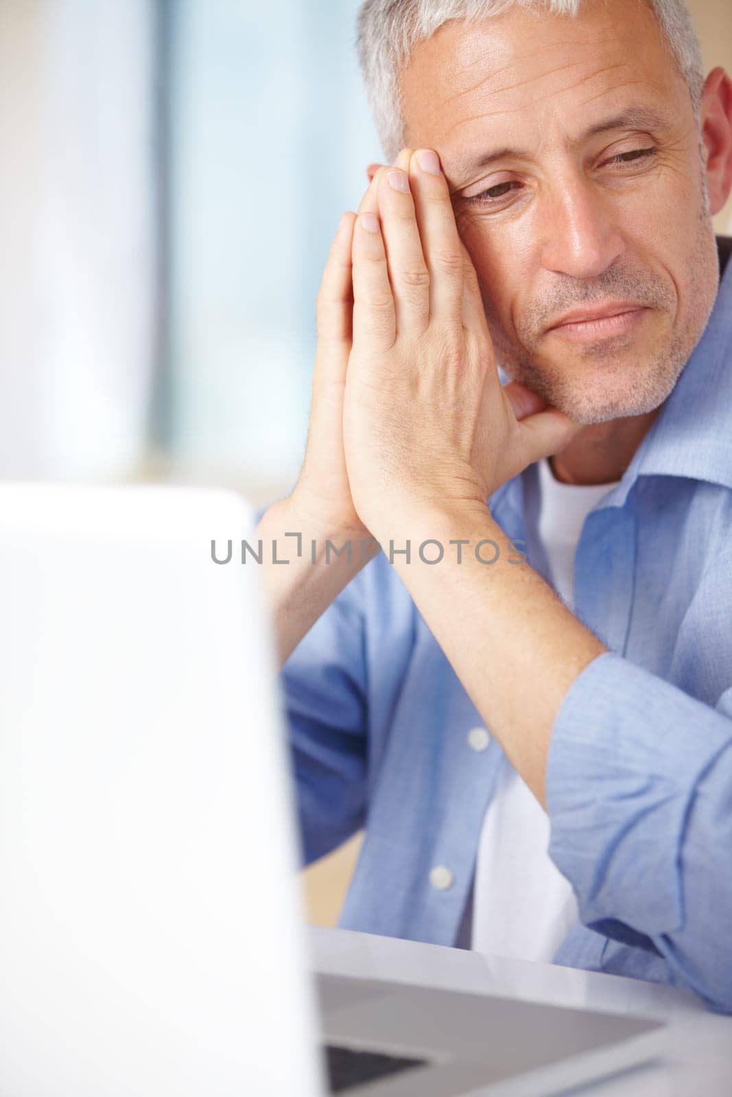 Mature man, laptop and thinking in home, serious face and stress for business. Hands, technology and communication for problems, vision and concerned with remote work, overworked and contemplating.